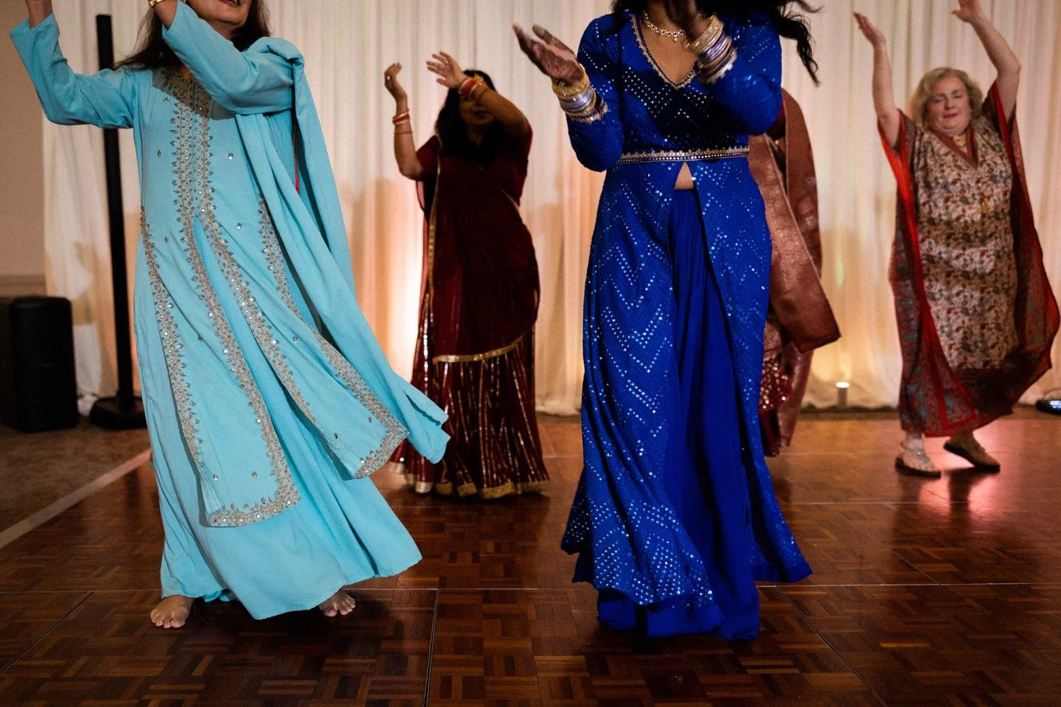 147_Oregon Golf Club Indian Wedding-12_women in blue and red saris dance during sangeet.jpg