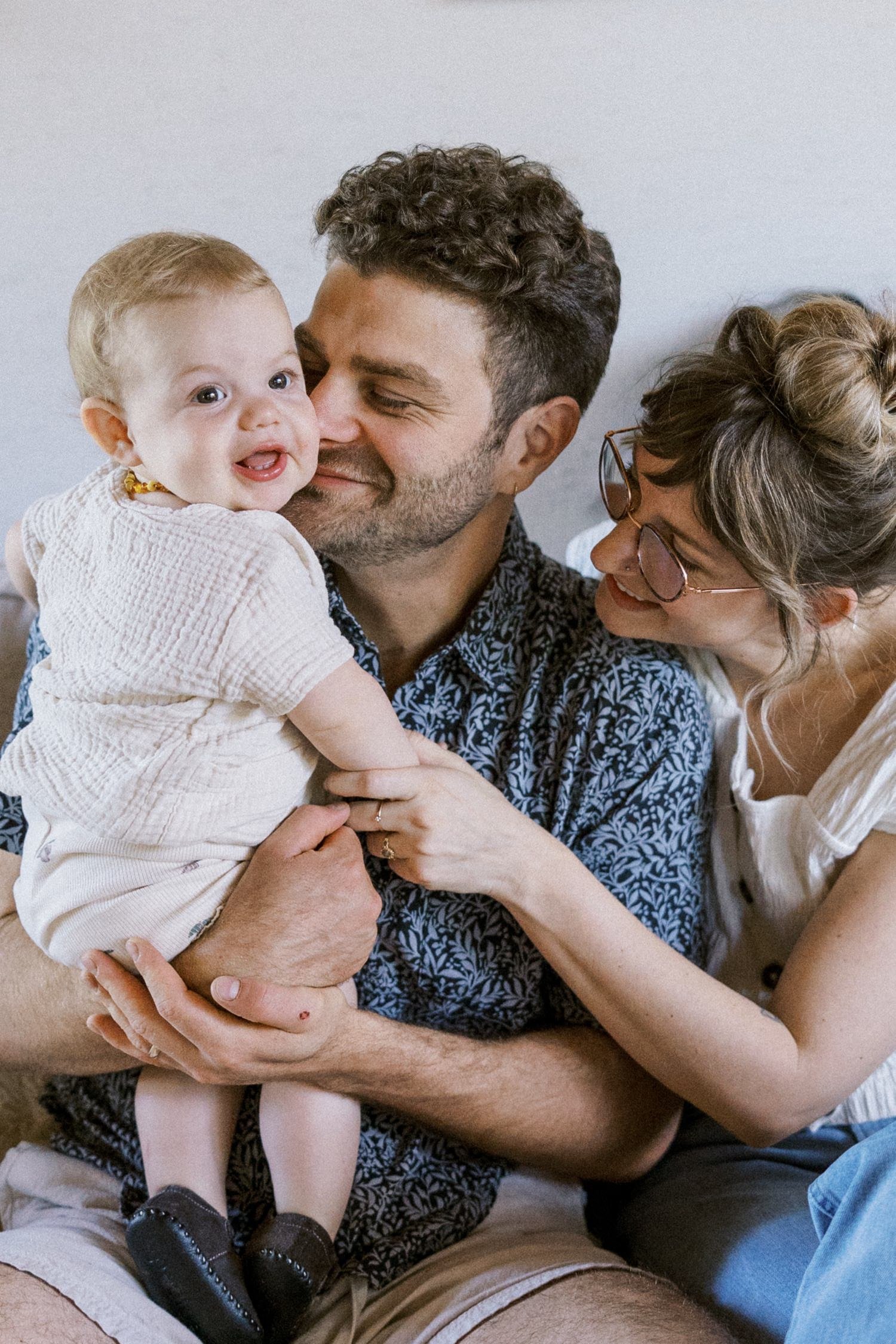 07_Portland Family Photographer-7086_dad snuggles into baby daughter while mom holds baby’s arm.jpg