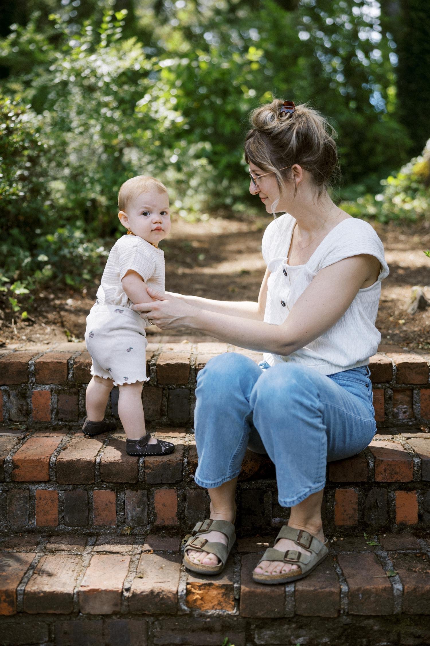 17_Portland Family Photographer-7635_mom and baby daughter sit on brick steps together in backyard.jpg
