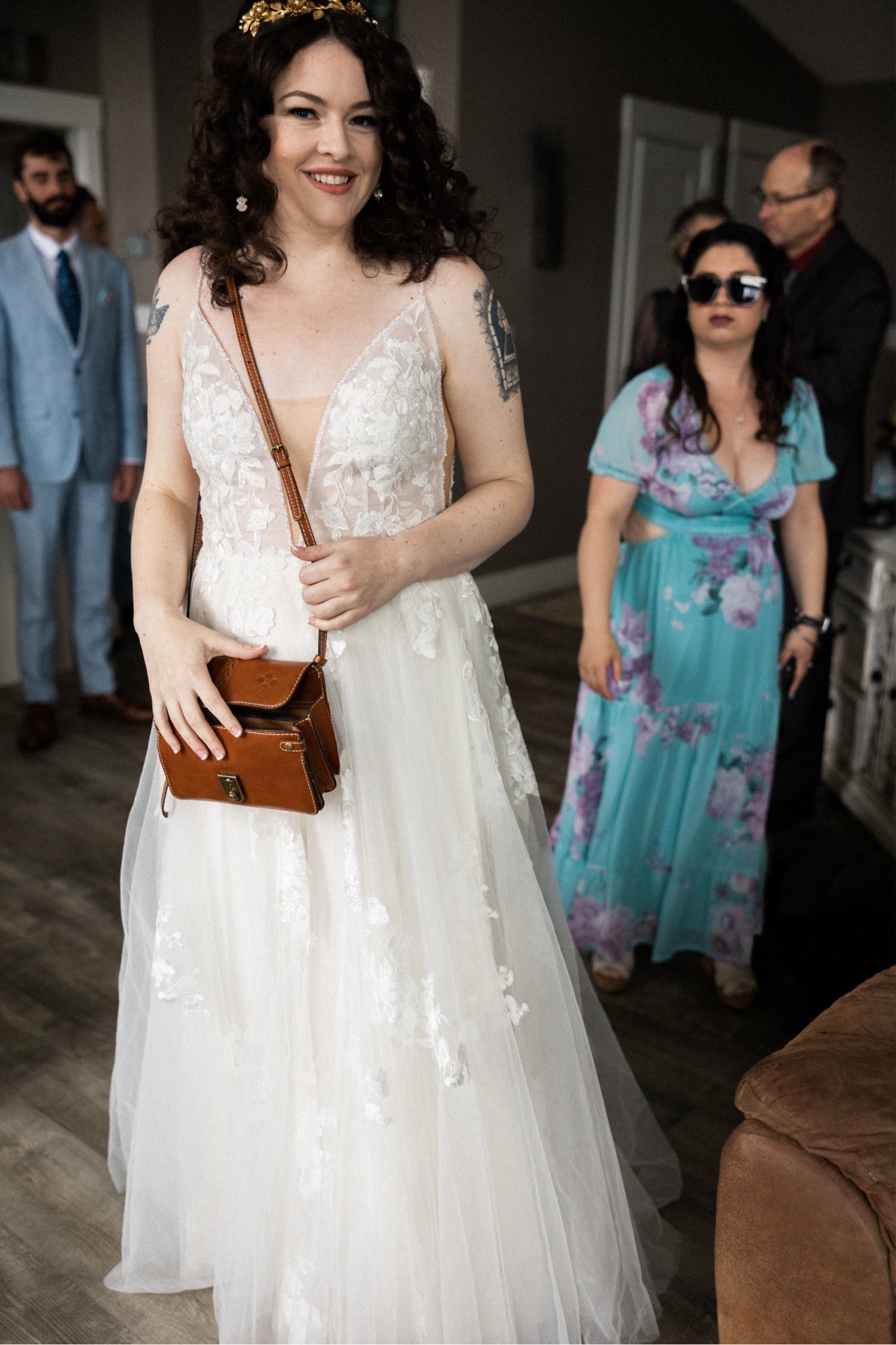 017_The Orchard Hood River Wedding50_bride holds brown leather purse.jpg