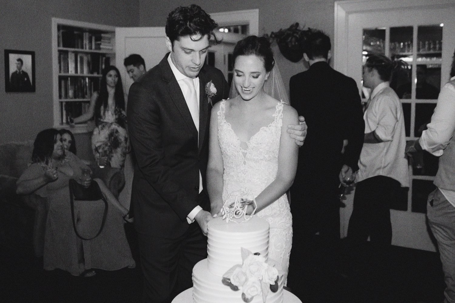  bride and groom cut wedding cake 