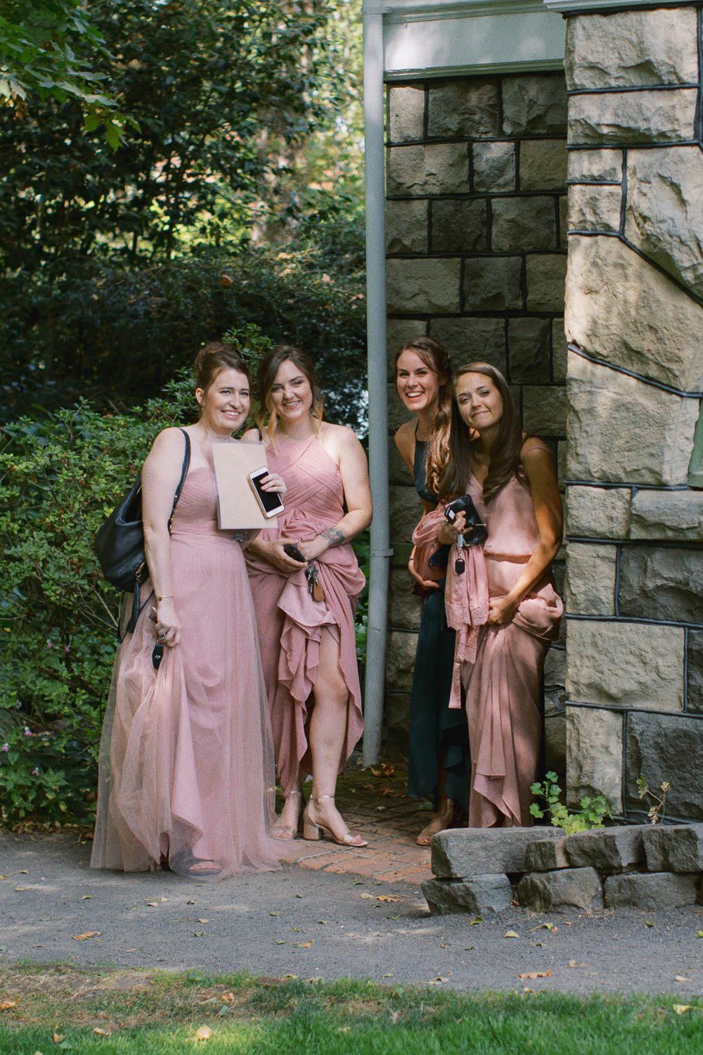  four women stand next to each other smiling at Deepwood Museum and Gardens wedding venue in Salem, Oregon 
