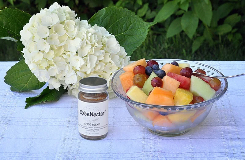 sprinkle SpiceNectar over fruits in a bowl