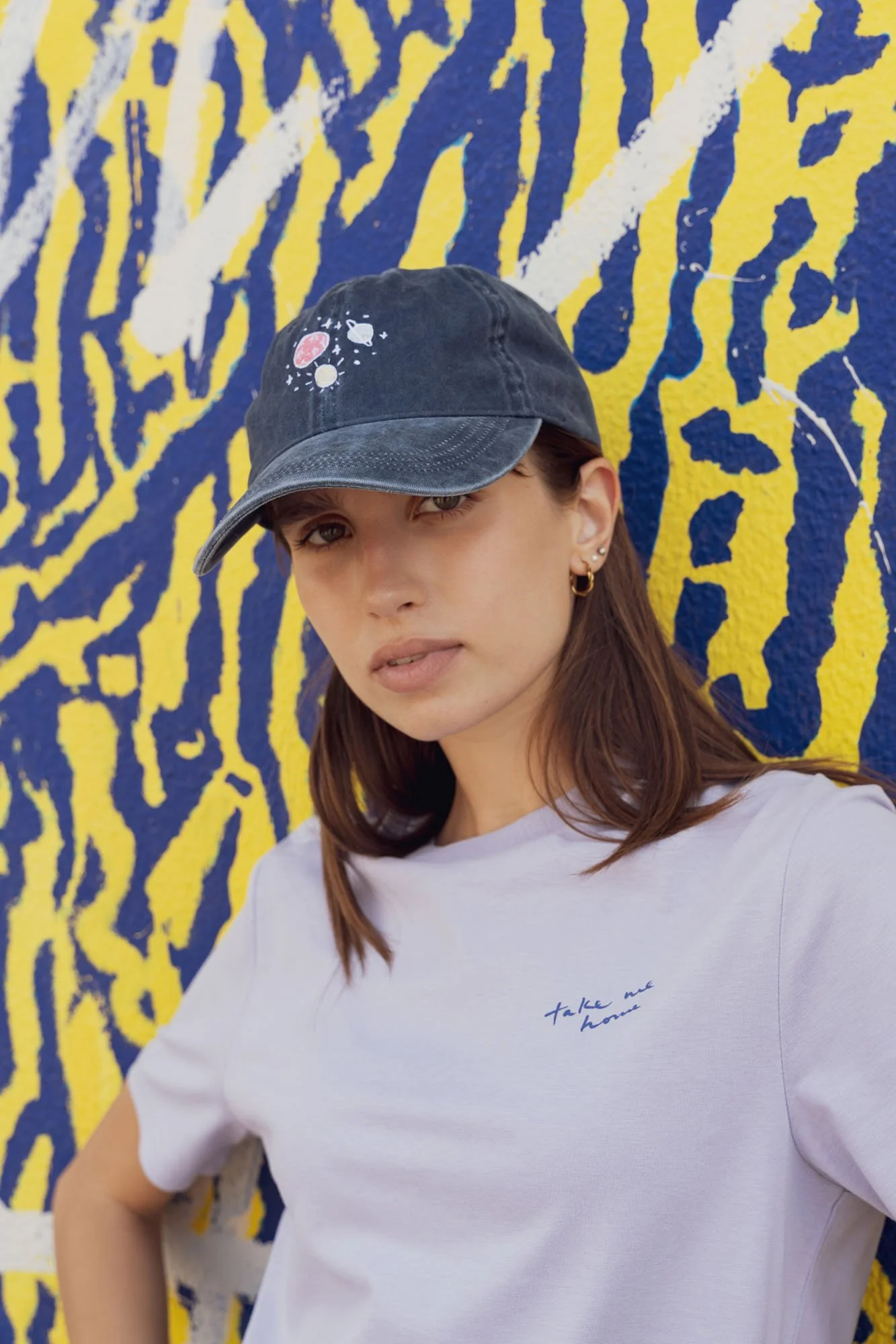 Woman wearing Contrast embroidered baseball cap in dark denim and lilac organic cotton t-shirt, sustainable fashion streetwear