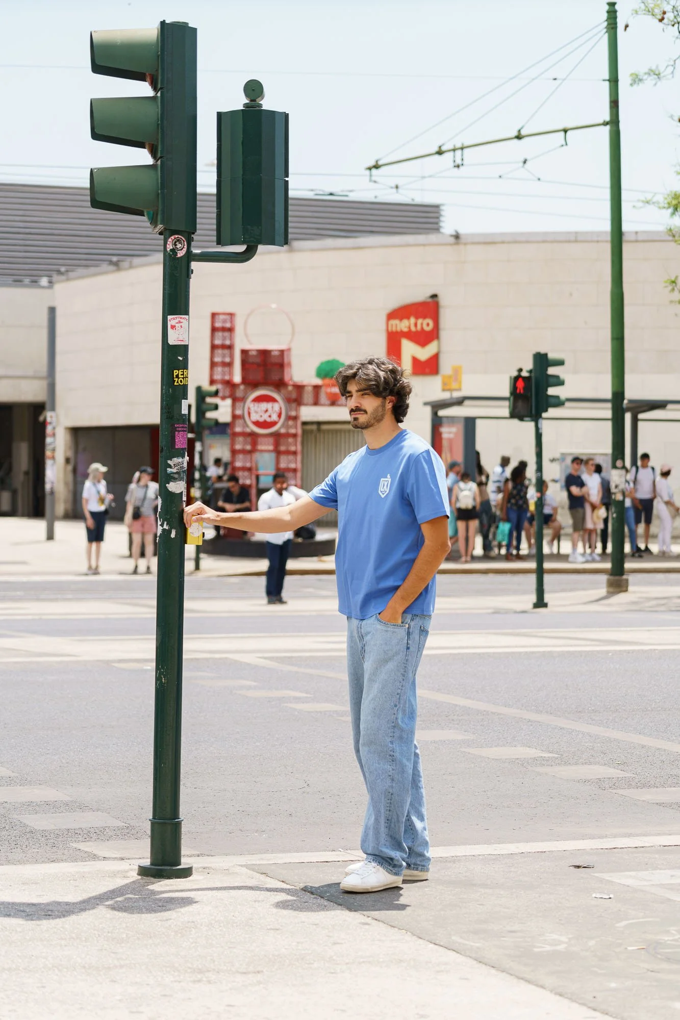 Man wearing Contrast blue organic cotton embroidered t-shirt with LX logo, sustainable minimalist streetwear photographed in Lisbon