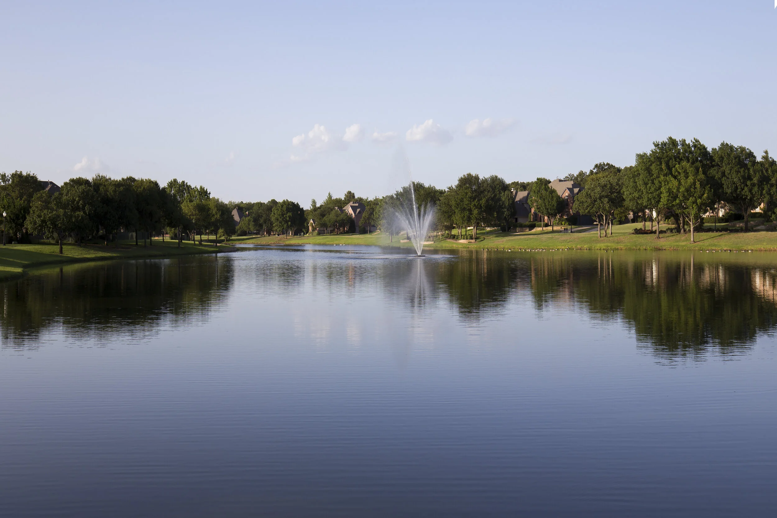 Lake surrounded by paved walking path