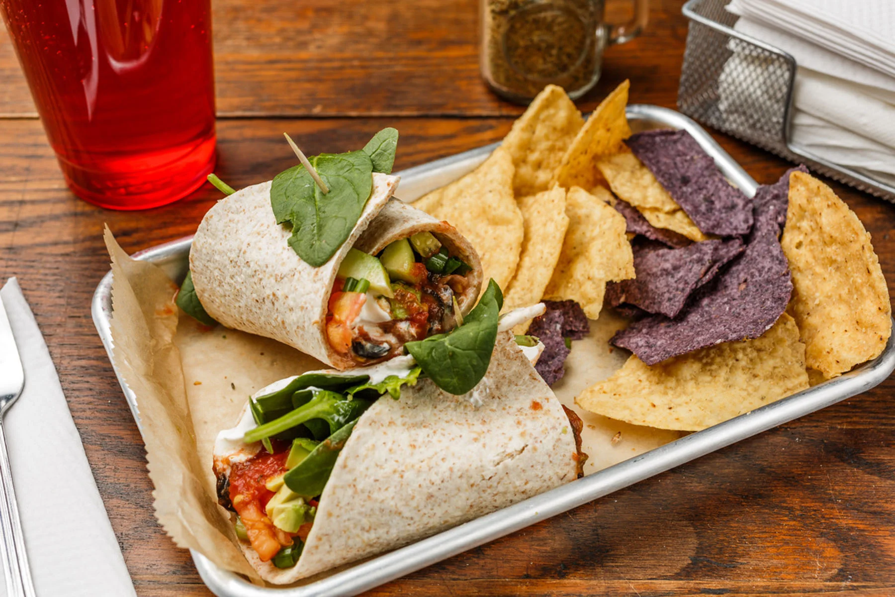 Veggie Burrito Organic whole wheat tortilla, avocado, tomato, green onions, jalapeño, cucumber, black olives, sour cream, salsa, and spinach or sprouts. Served with organic tortilla chips. $6.49