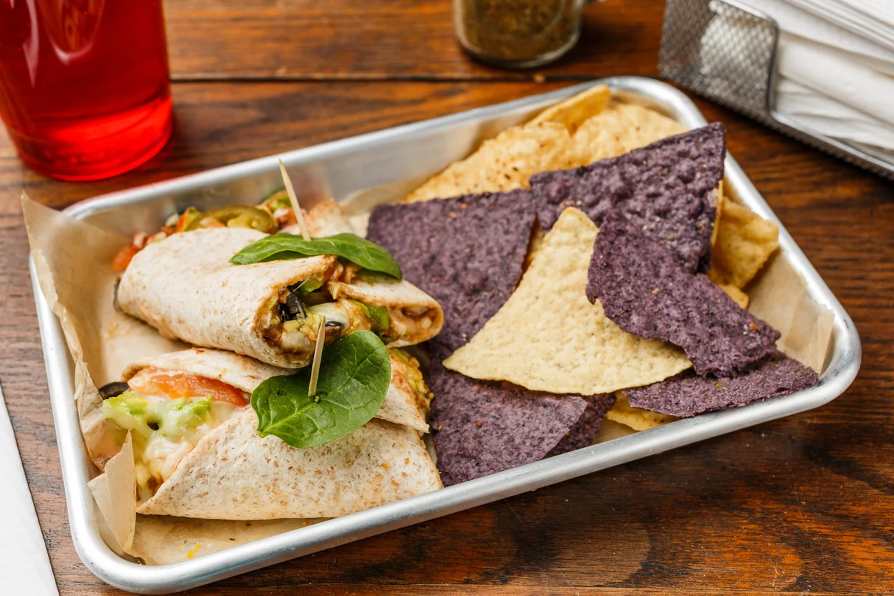 Mucho Burrito Organic whole wheat tortilla, black or pinto beans, cream cheese, avocado, green onions, tomato, black olives, jalapeño, Monterey Jack cheese, and salsa. Served with organic tortilla chips. $7.49