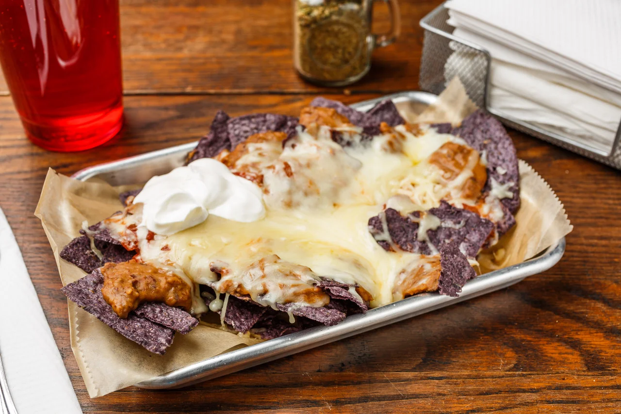 Nachos Organic blue corn chips, pinto beans, sour cream, salsa, and Monterey Jack cheese.. $7.39