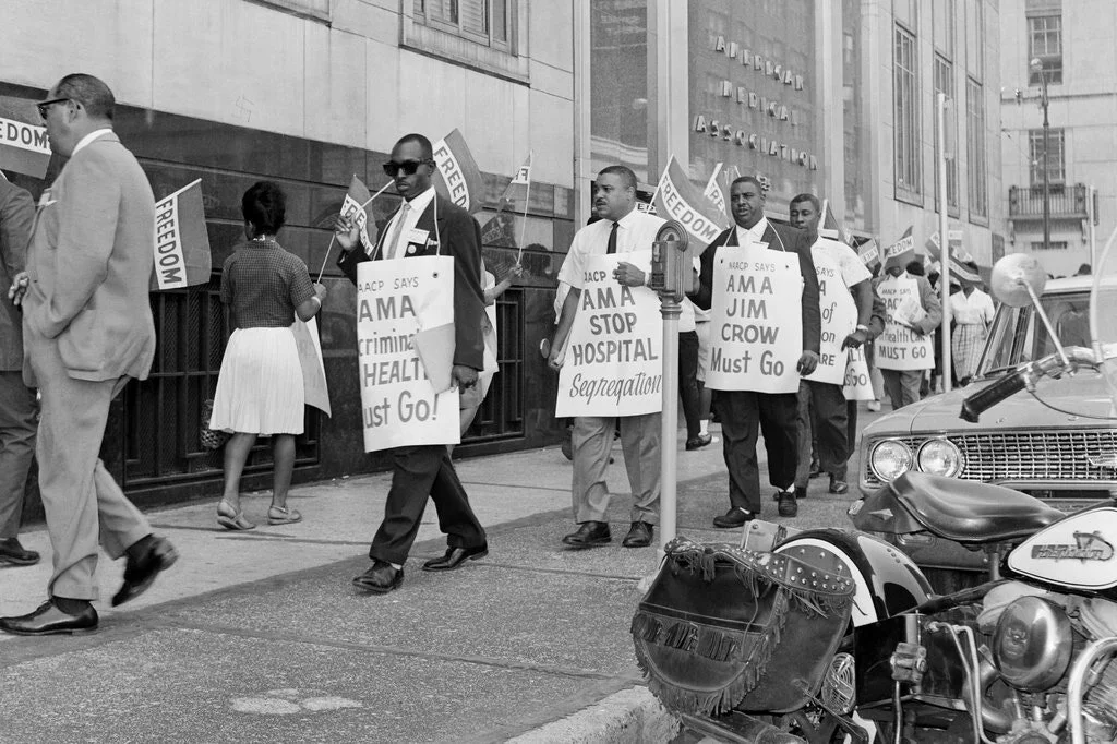 Protesters marching against hospital segregation and health care inequality in front of the American Medical Association’s Chicago headquarters in 1963. Bettmann, via Getty Images
