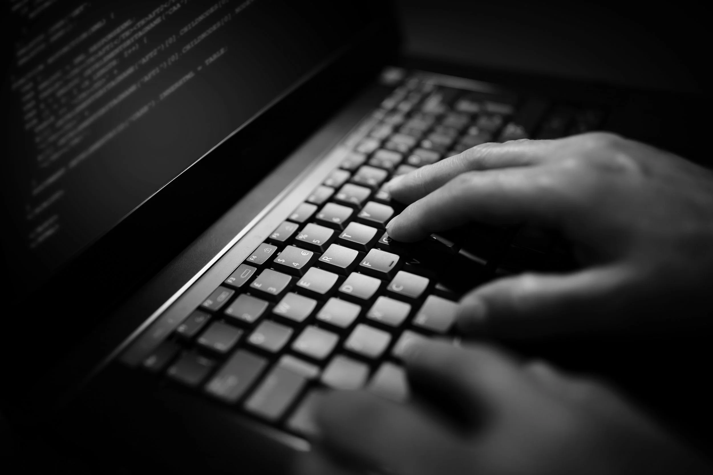 programmer-or-computer-hacker-typing-on-laptop-PSAN67J..jpg