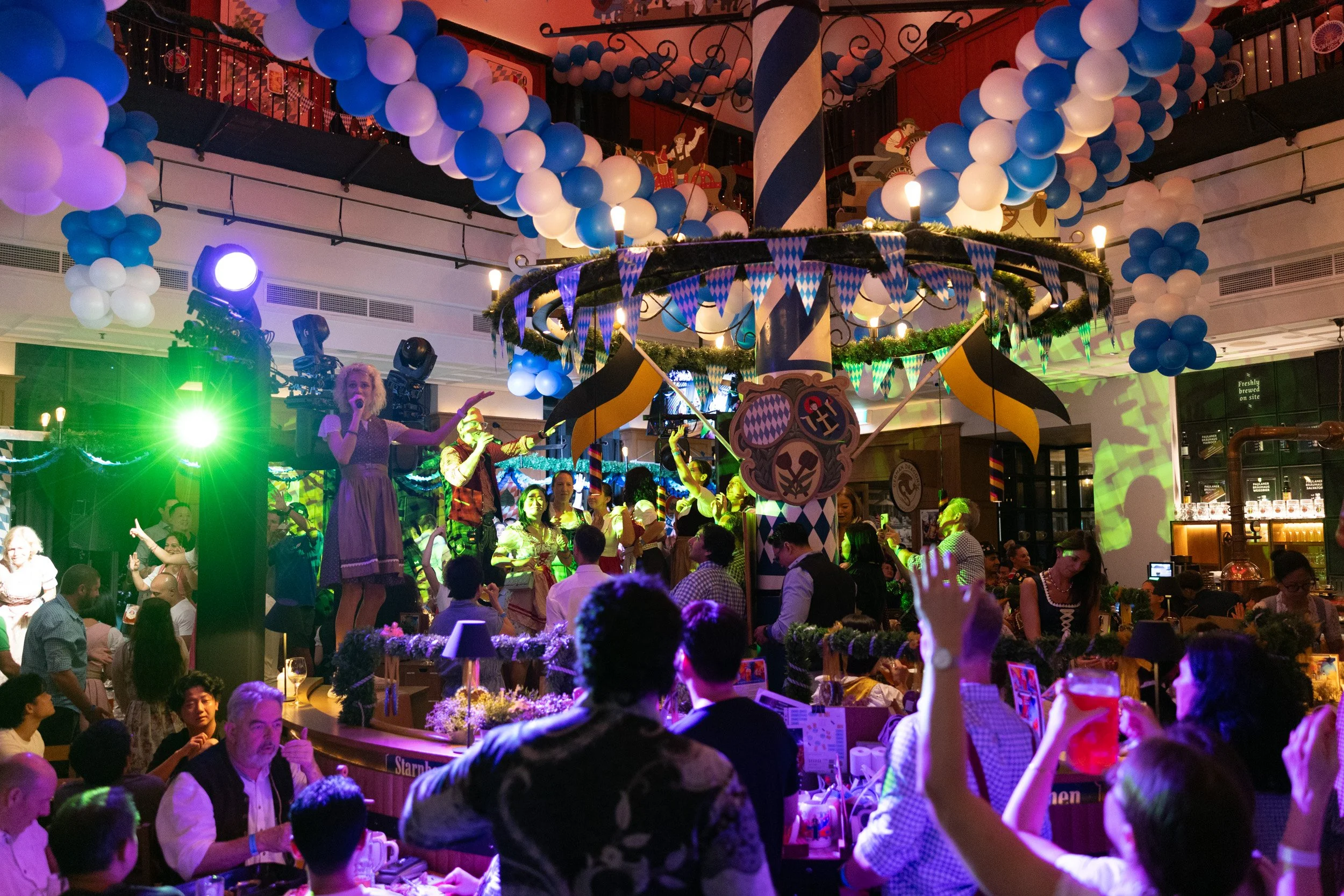  Energetic live stage and tabletop performance during Paulaner Bräuhaus Oktoberfest 