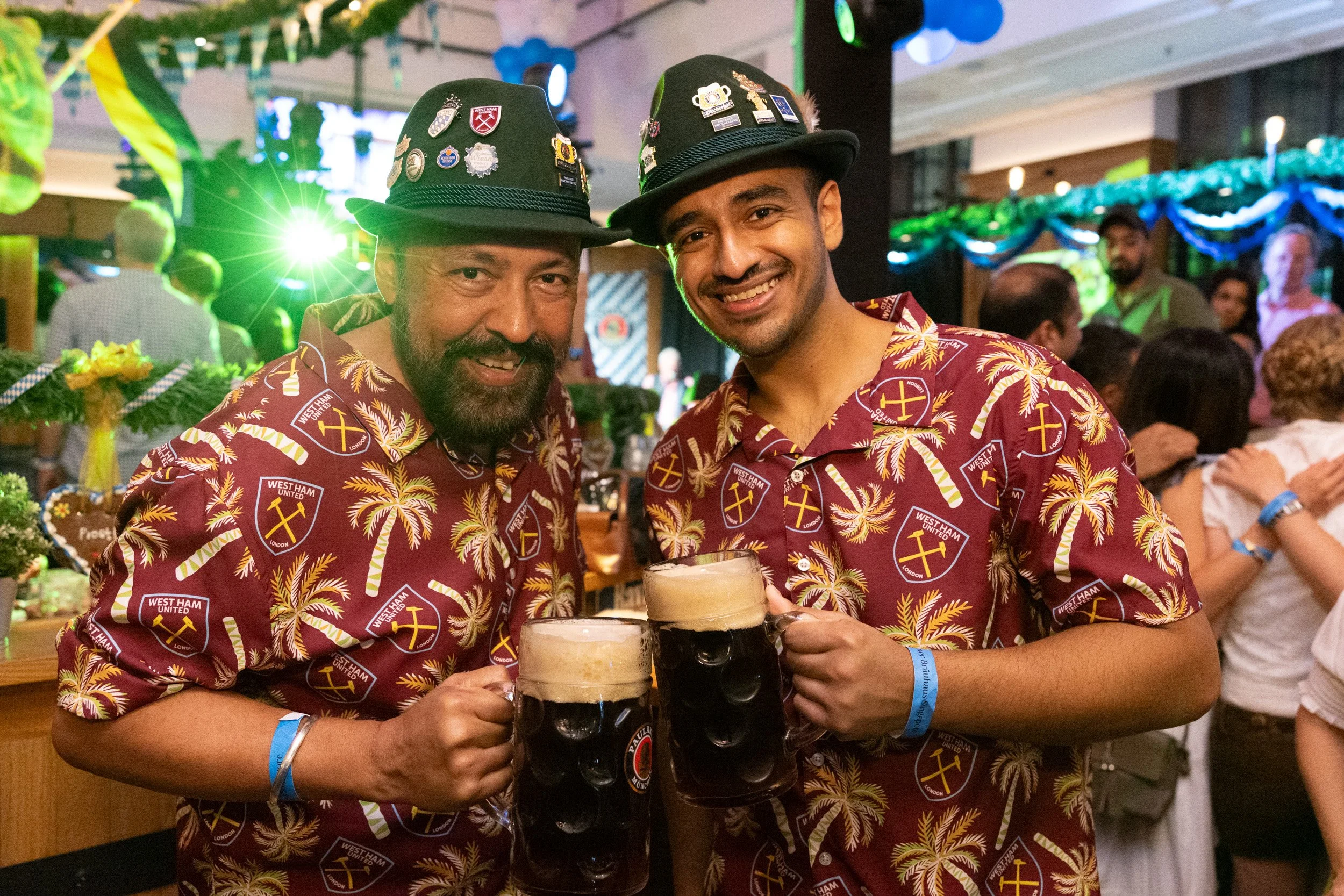  Group photo of event guests celebrating with traditional German beer at Millenia Walk 