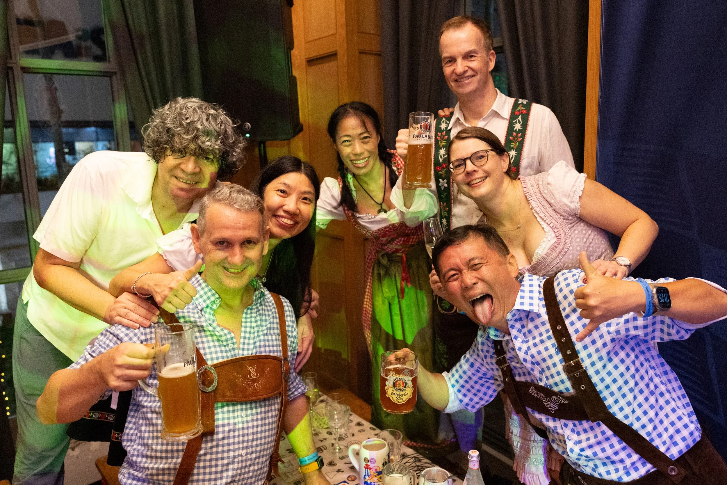  Group of guests holding up beer mugs for a staged portfolio shot at Oktoberfest 