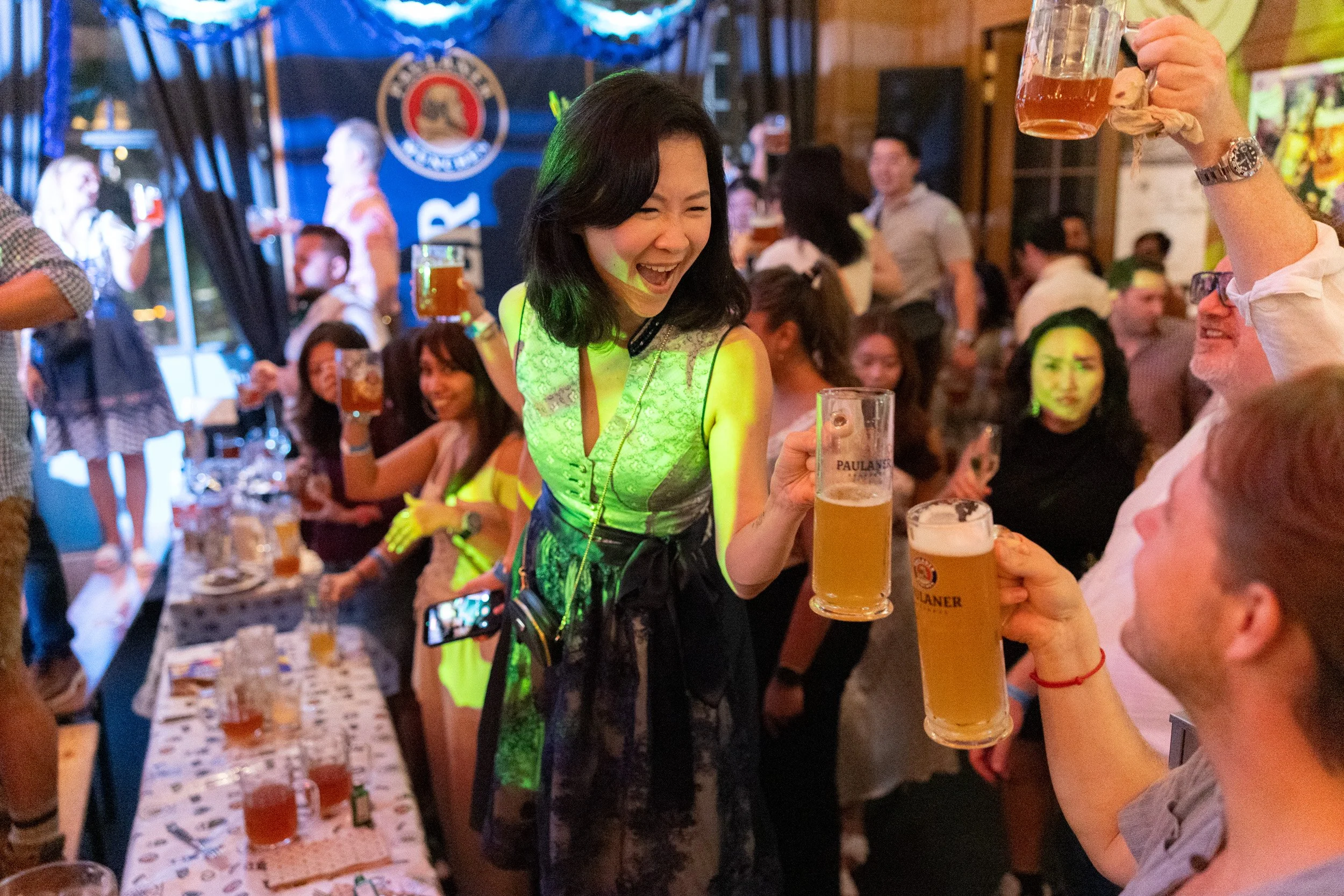  Candid couple toasting with German beer mugs at Oktoberfest event in Singapore 