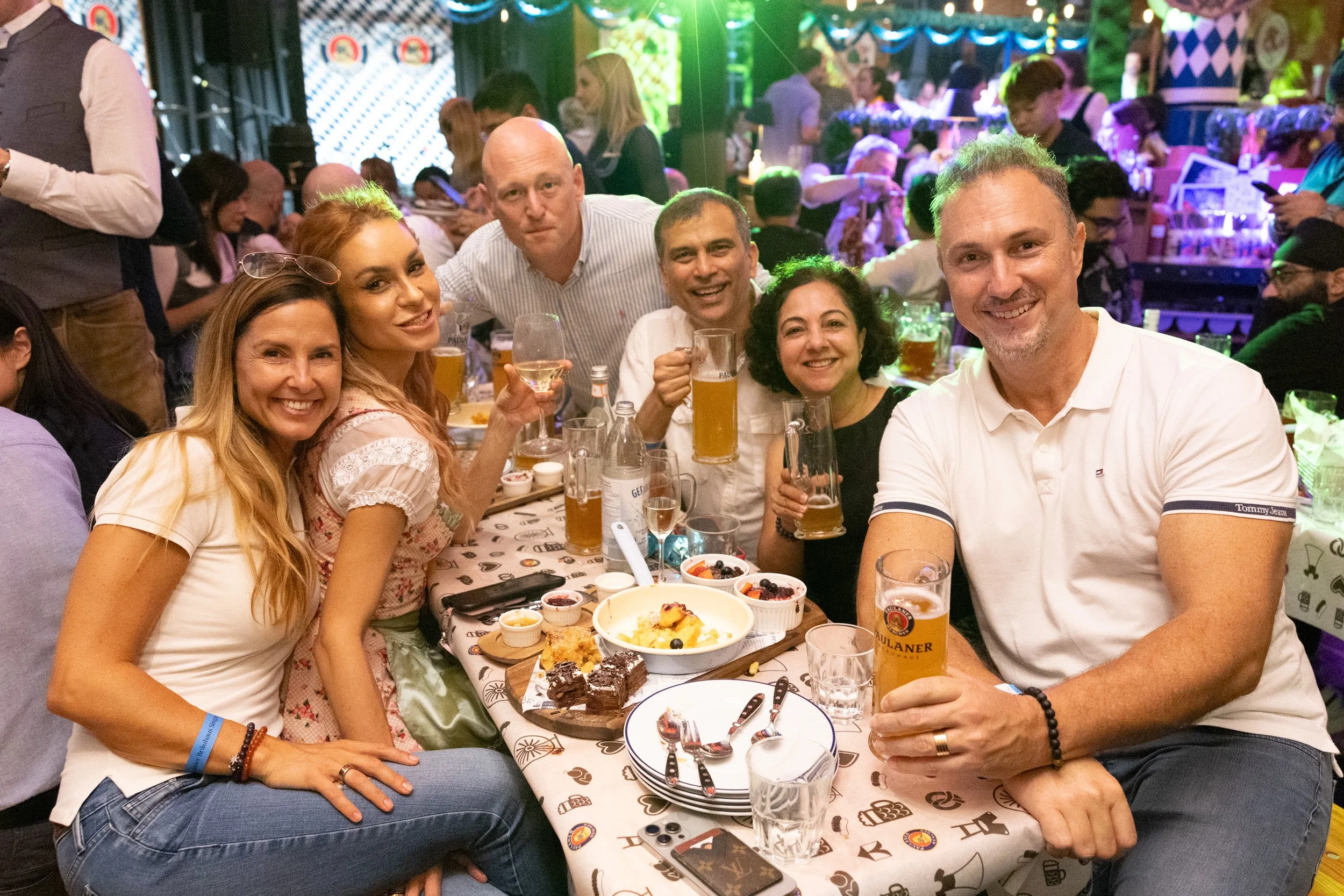  Group portrait of attendees toasting with beer mugs during Oktoberfest celebrations 