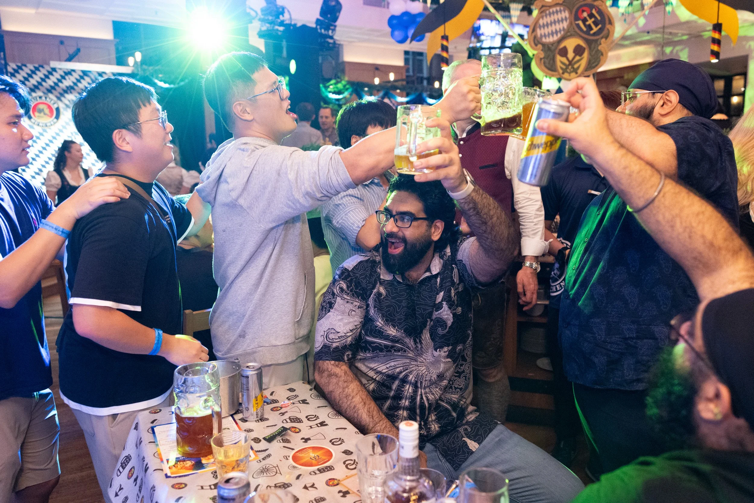  Candid group toast with beer mugs during live event at Paulaner Bräuhaus Singapore 
