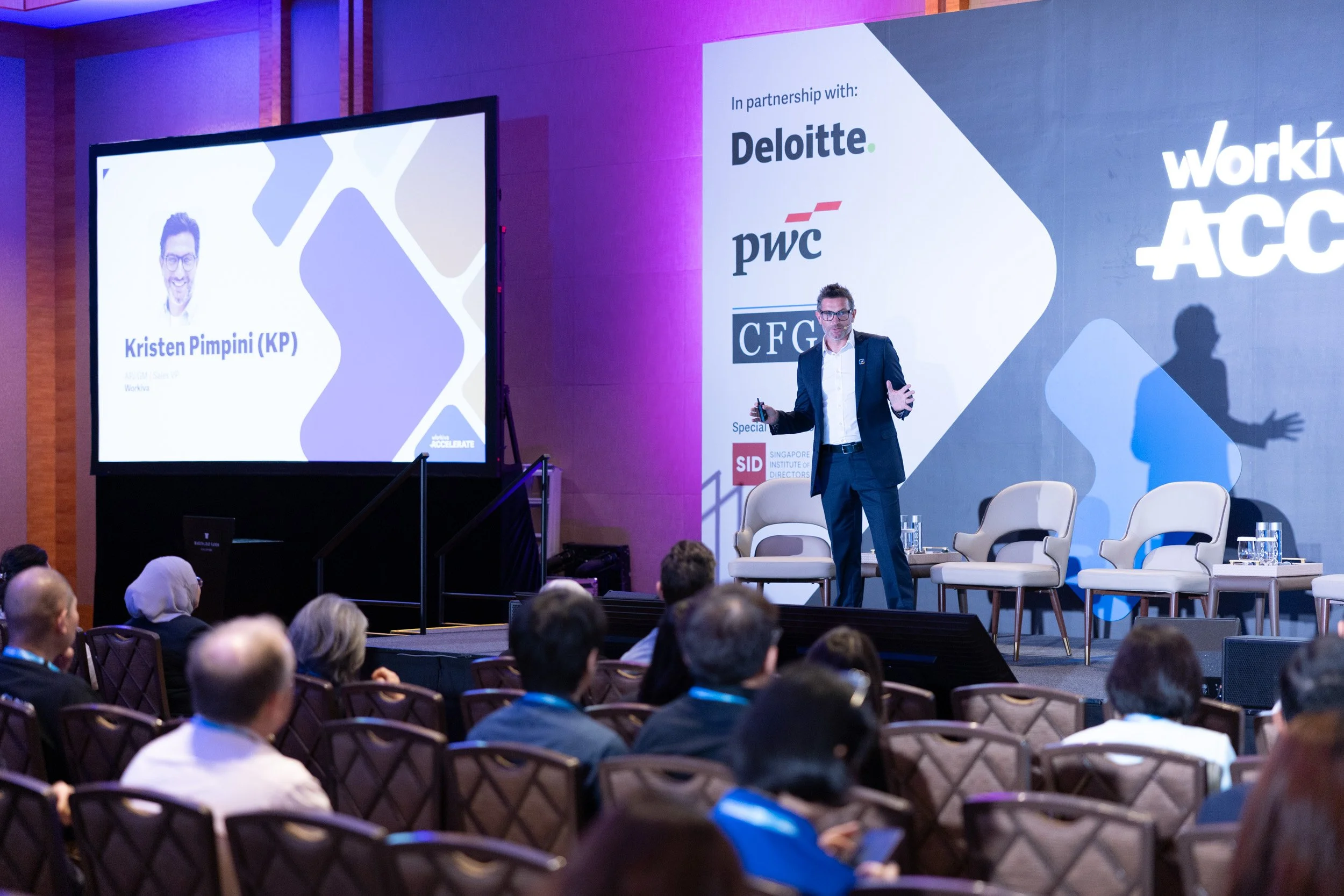  Speaker Kristen Pimpini presenting on stage at Workiva Accelerate Asia in Singapore. 