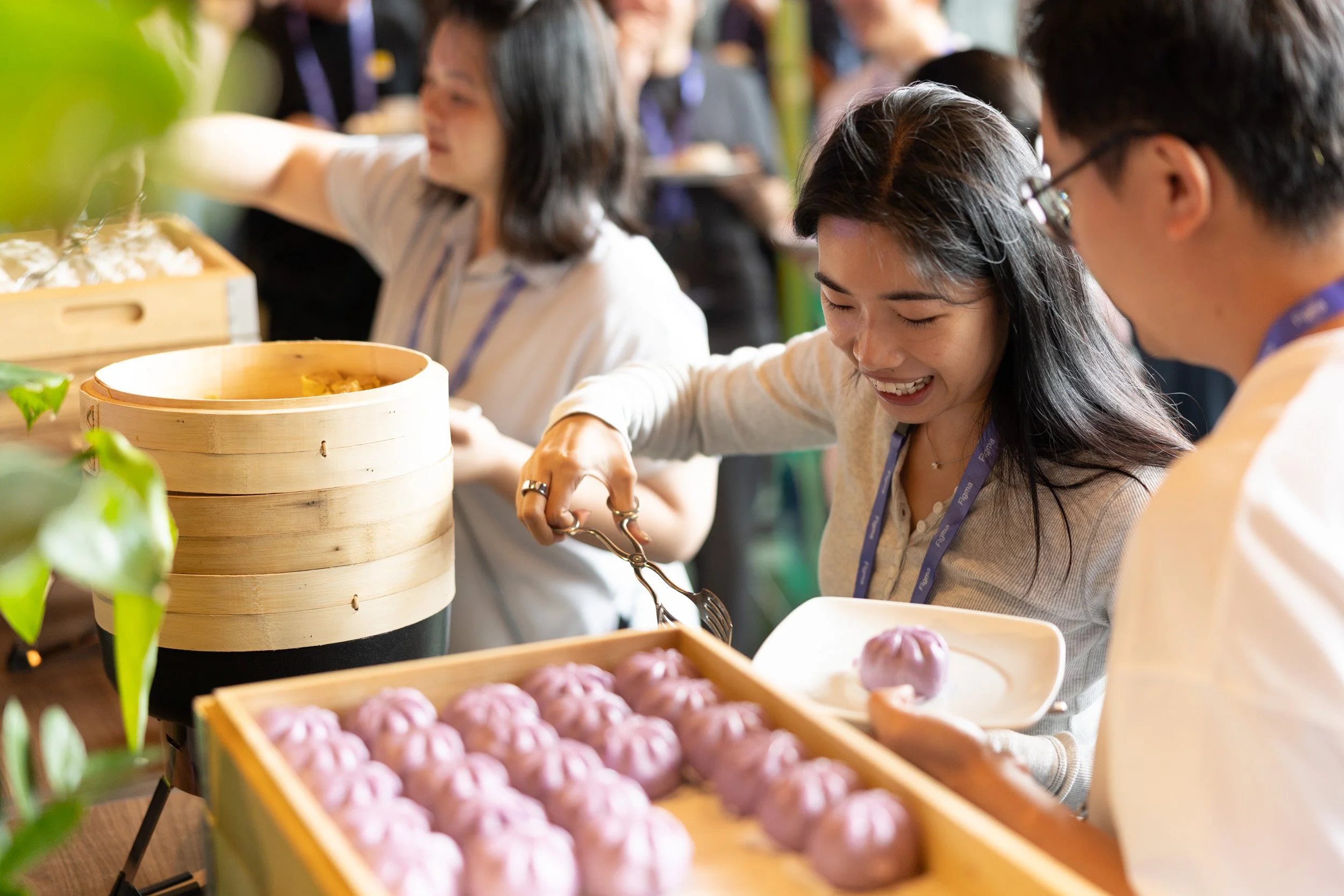  Close up view of event guests enjoying food during a catering break. 