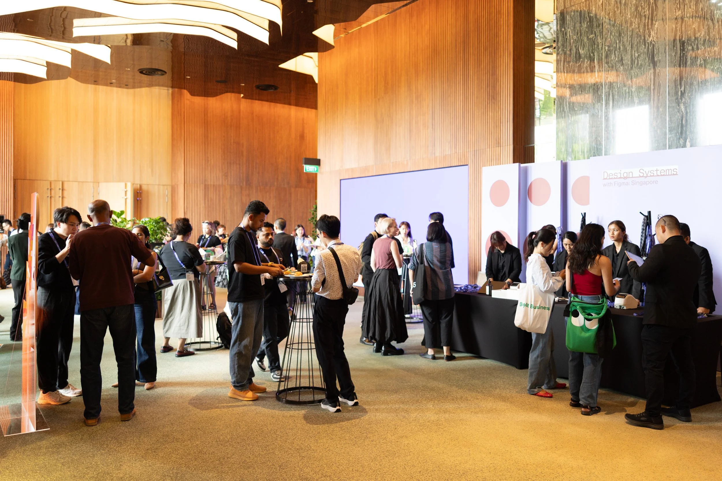  Wide angle shot of attendees gathered and networking during Design Systems with Figma. 