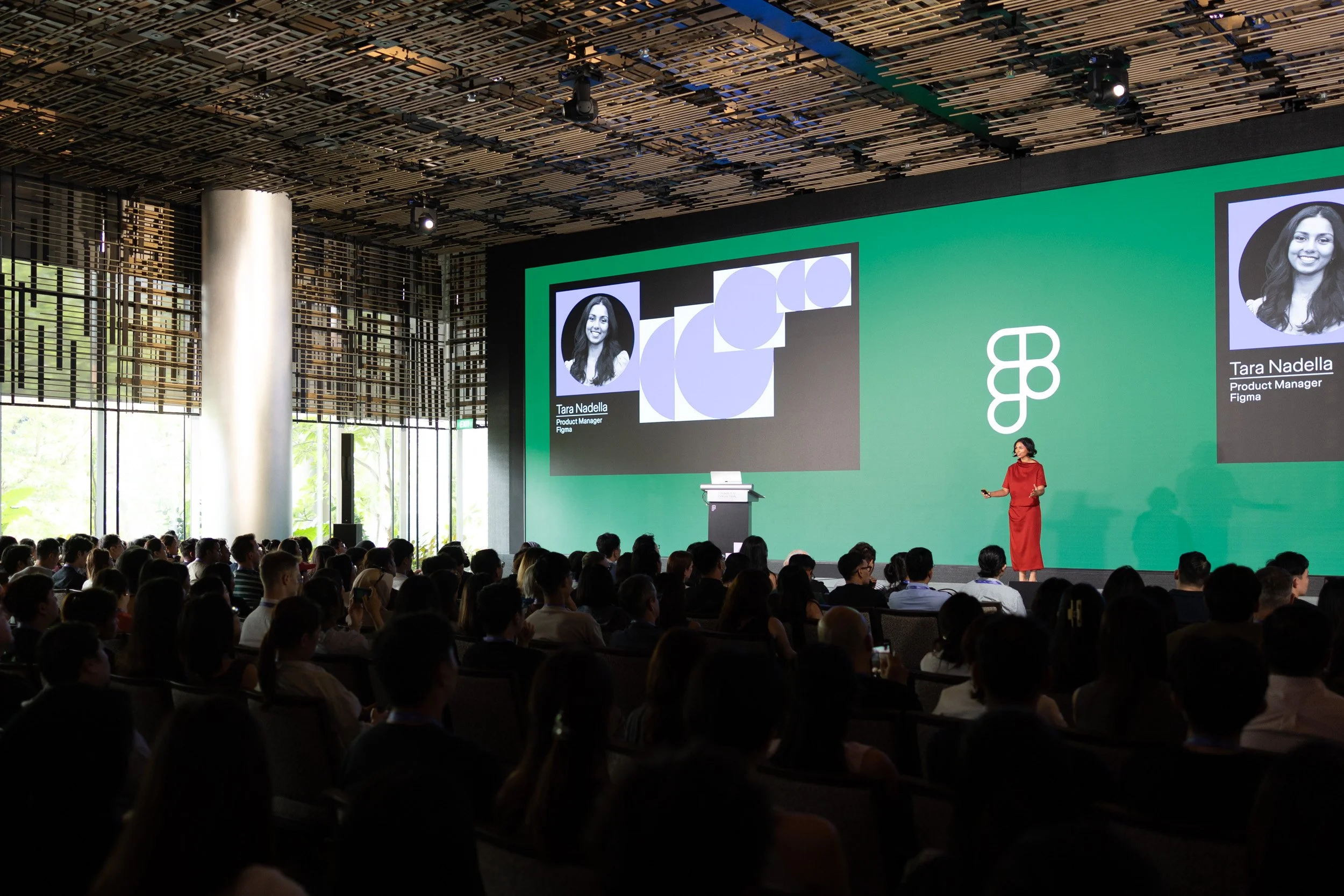  Wide angle stage view of presenter Tara Nadella speaking to event attendees. 