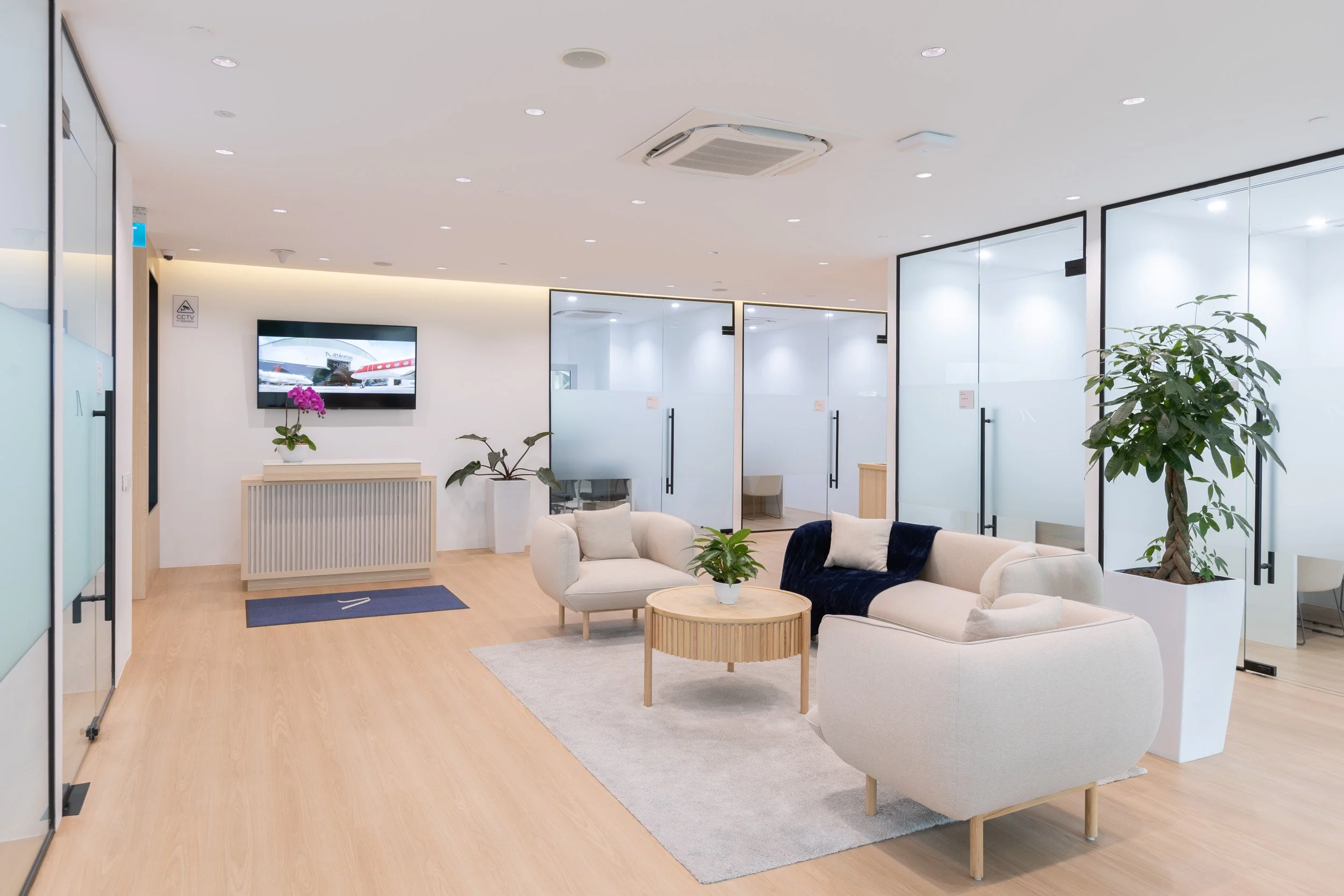  Jet Aviation luxury facility interior highlighting executive lounge seating and customer service reception desk. 