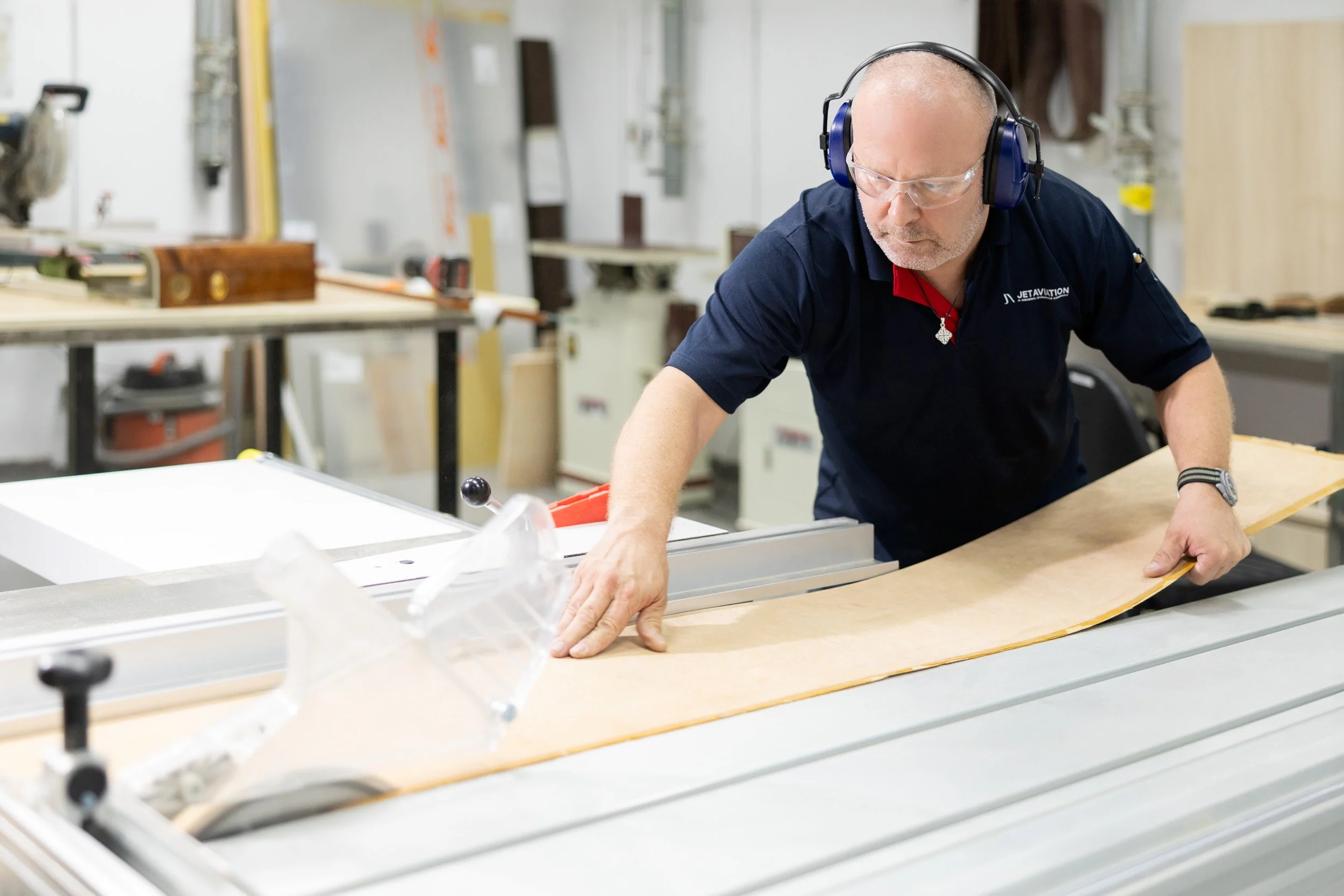  Skilled specialist using precision machinery to cut timber for bespoke private jet interior refurbishments. 