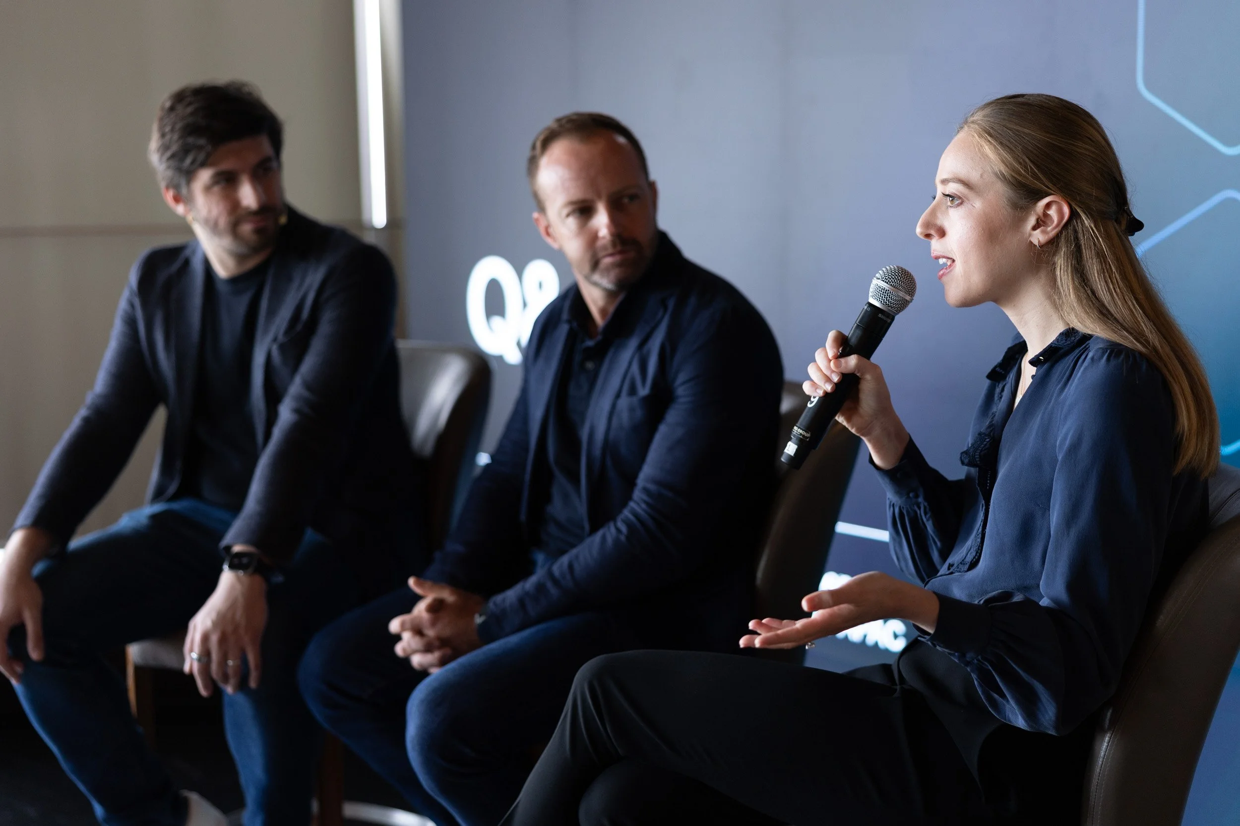  Emily Cohen answering audience questions during the press conference Q&amp;A session with Richard Spence in the background. 