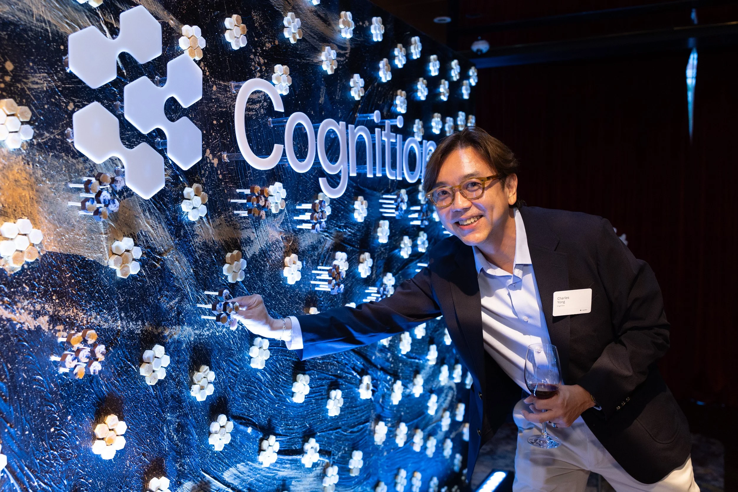  Event attendee picking a custom chocolate treat from the interactive Janice Wong feature wall. 