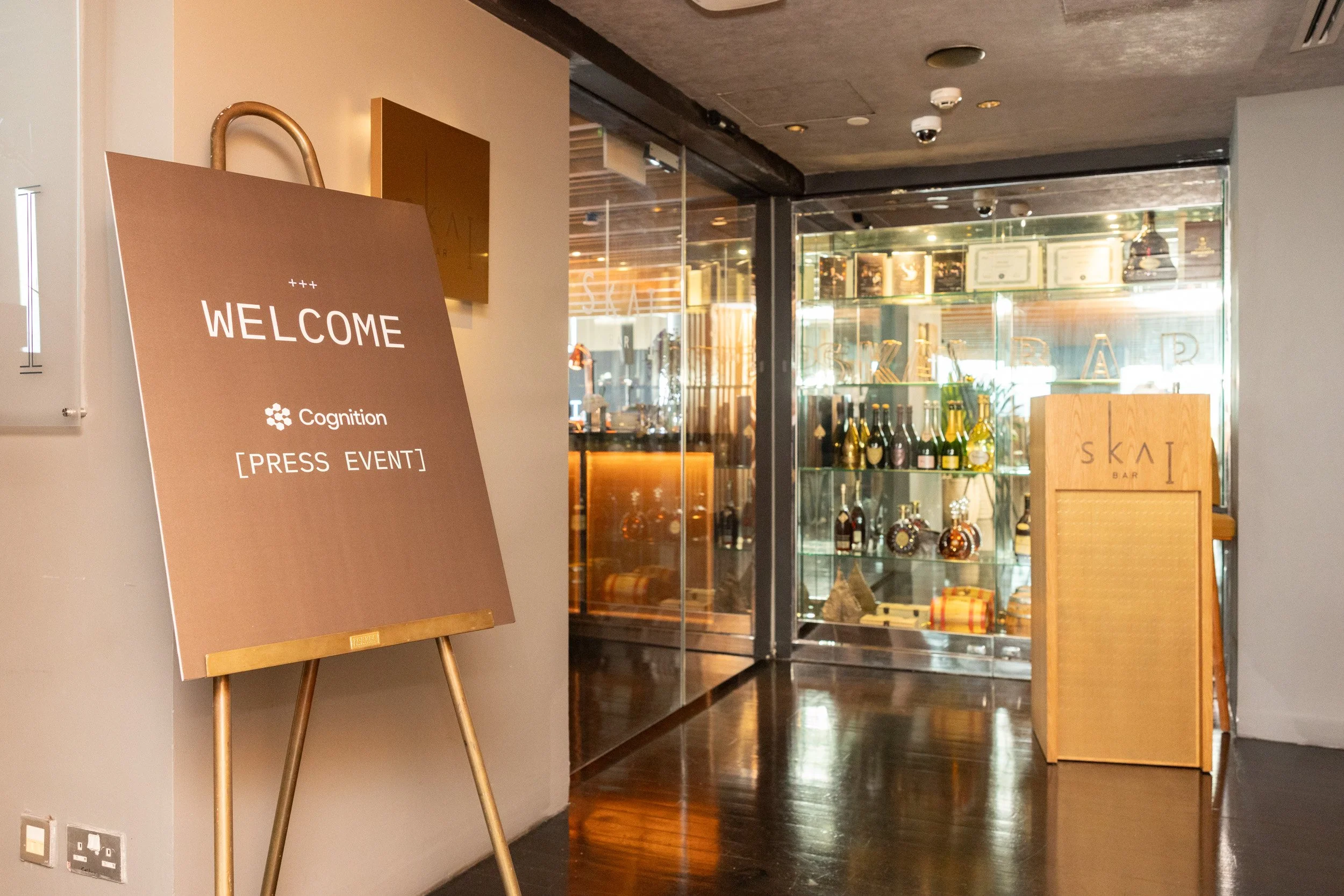  Welcome signboard displaying Cognition event branding at the entrance of SKAI Bar Singapore. 