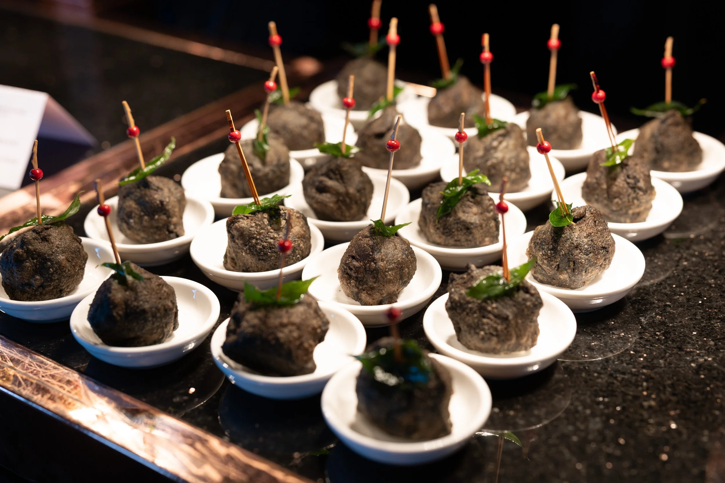  Close-up photo of gourmet pass-around canapés served during the Cognition press briefing at SKAI Bar. 