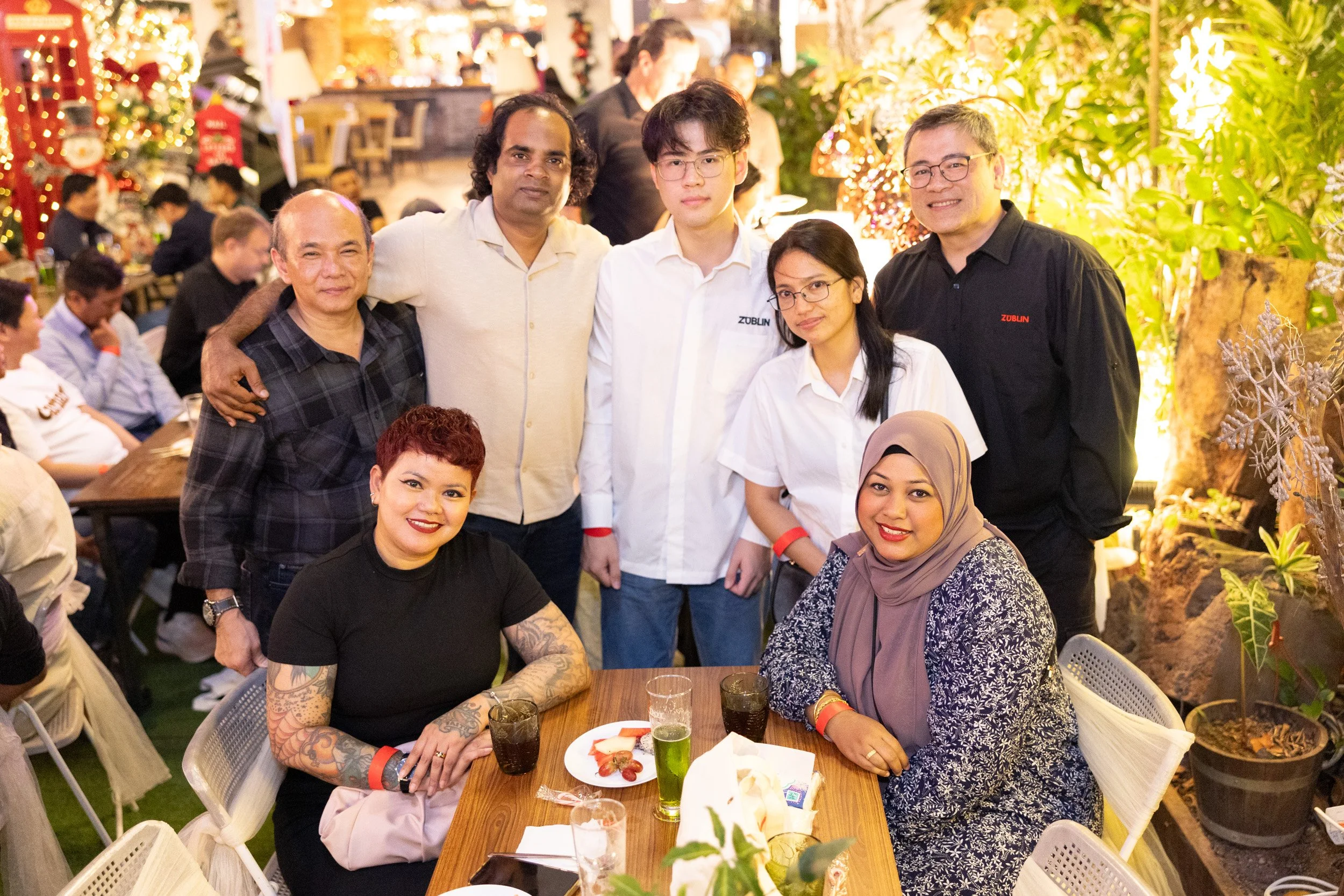  Group portrait of Züblin team members smiling together around a dinner table at RedDot Brewhouse. 