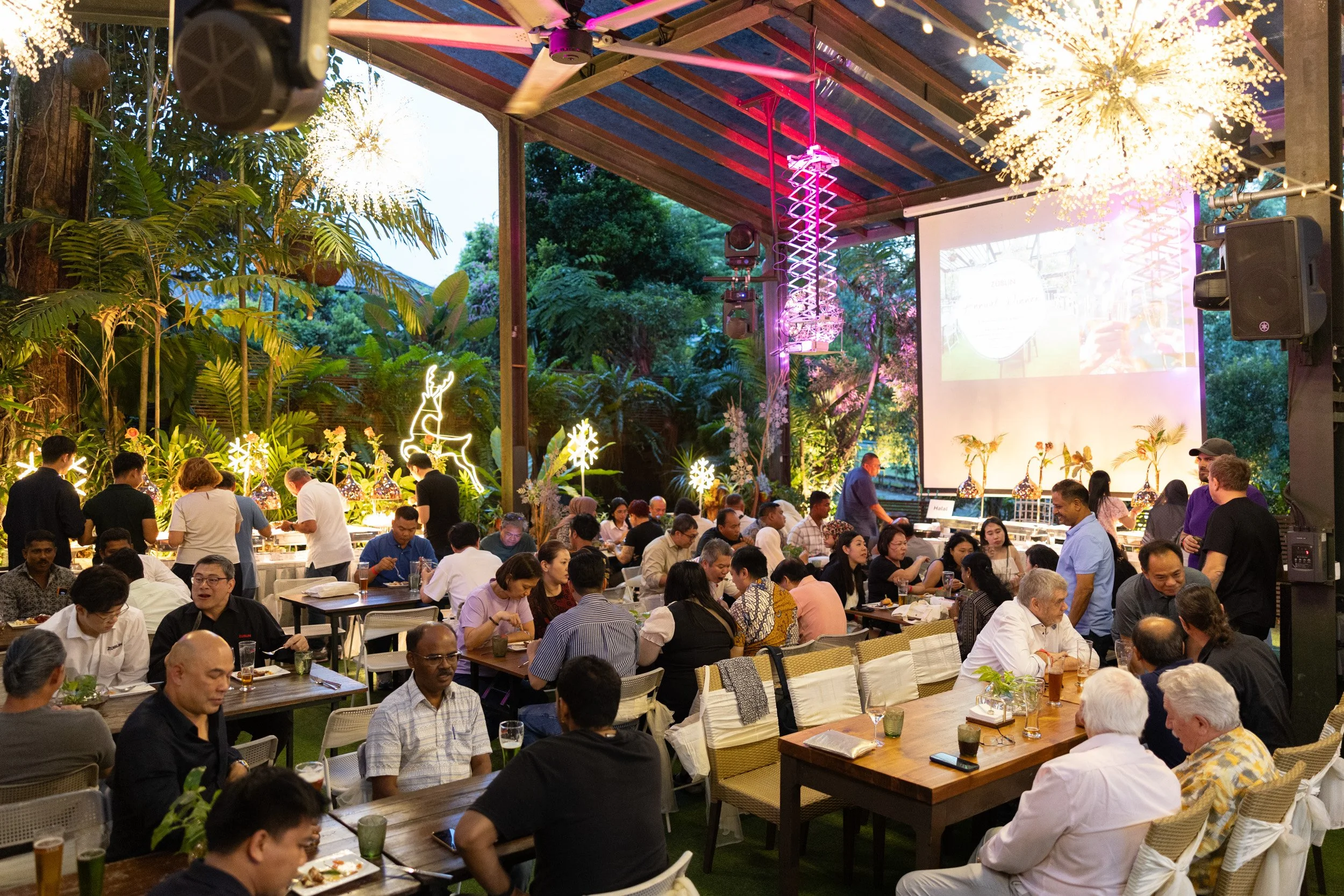  Evening ambience and wide view of the outdoor dining area at RedDot Brewhouse during the corporate dinner. 