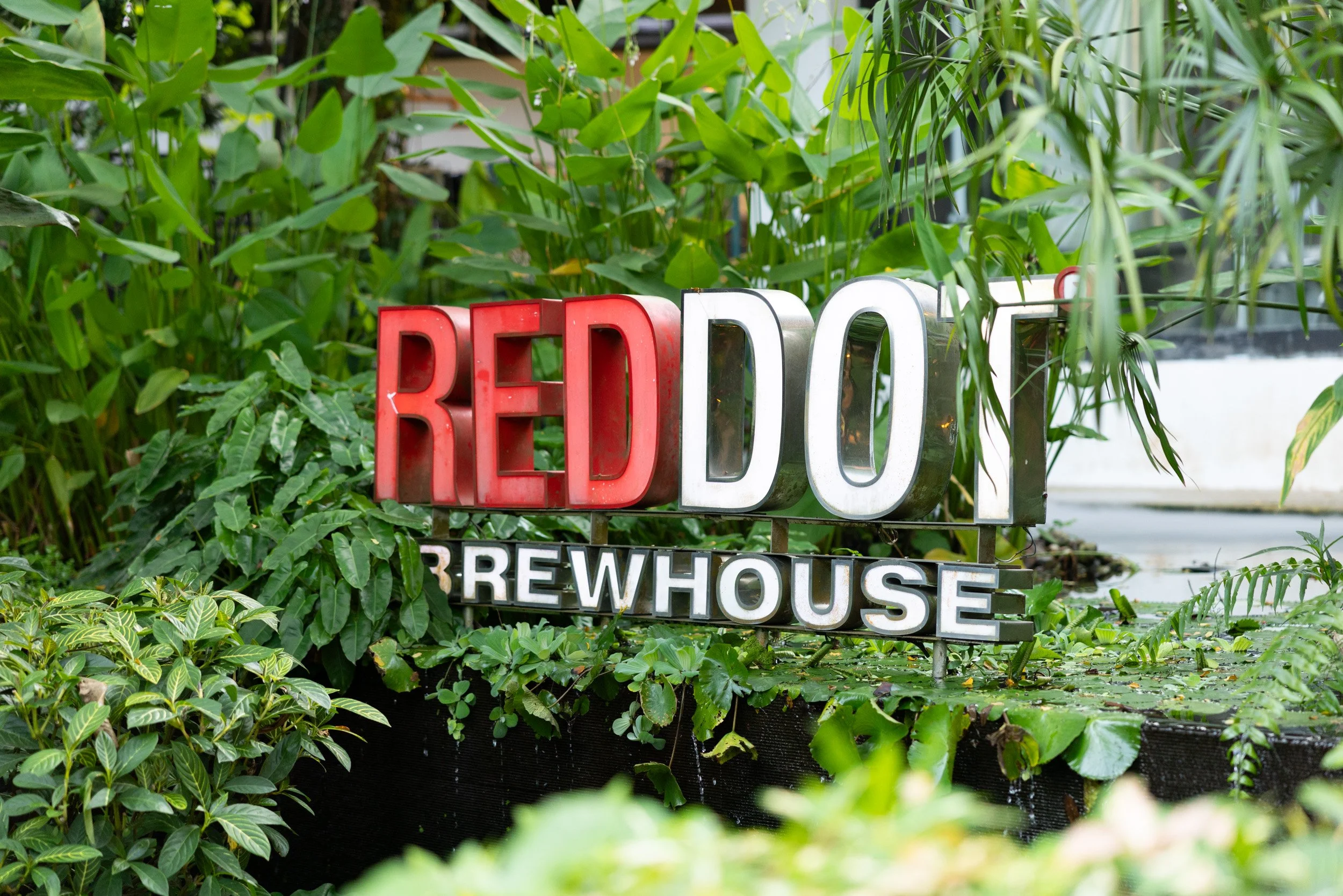 Architectural close-up photo of the RedDot Brewhouse logo at the restaurant venue entrance. 