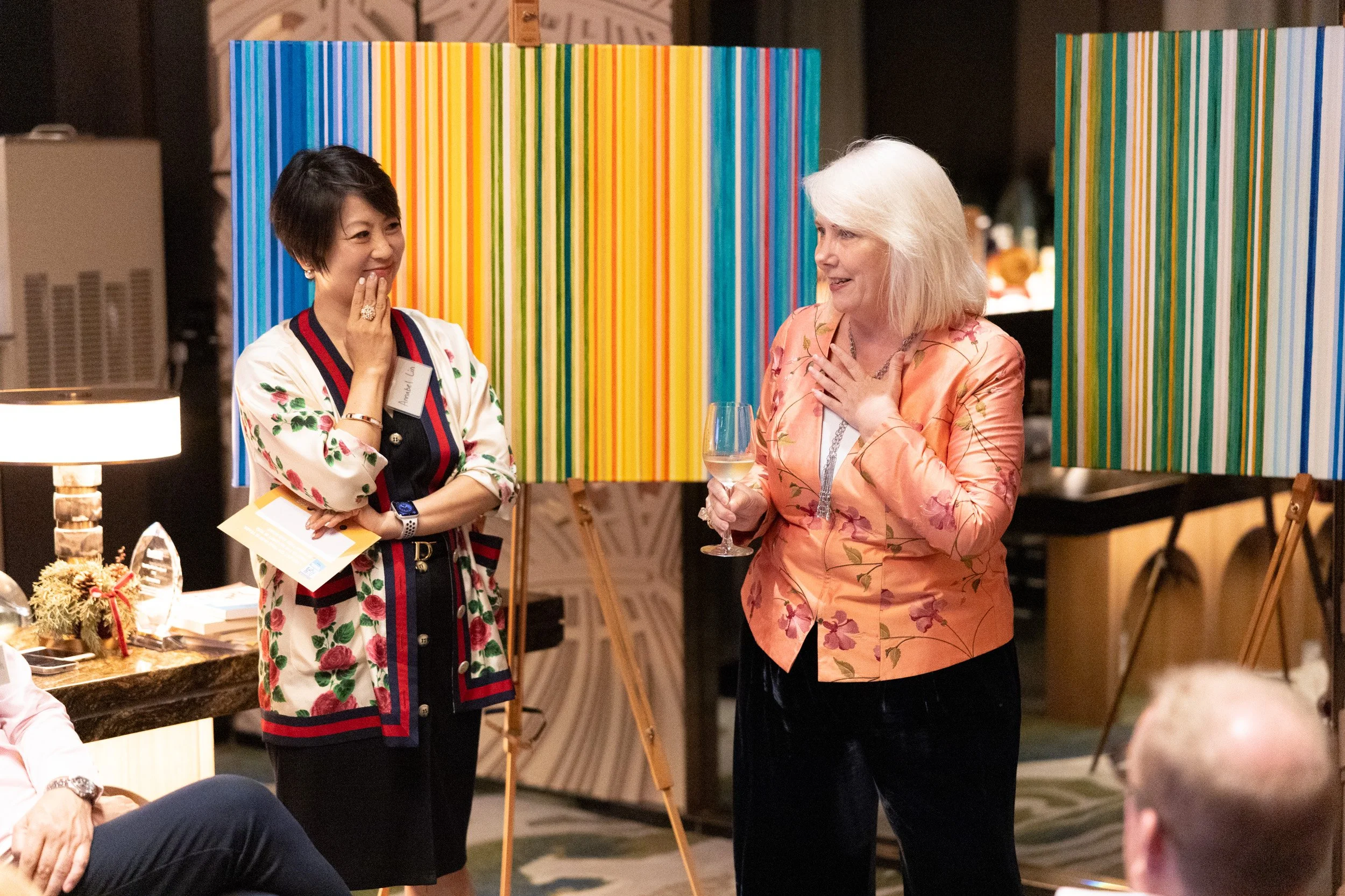  Detailed shot of Joanne Flinn and Annabel Lin engaging with guests during their keynote address. 