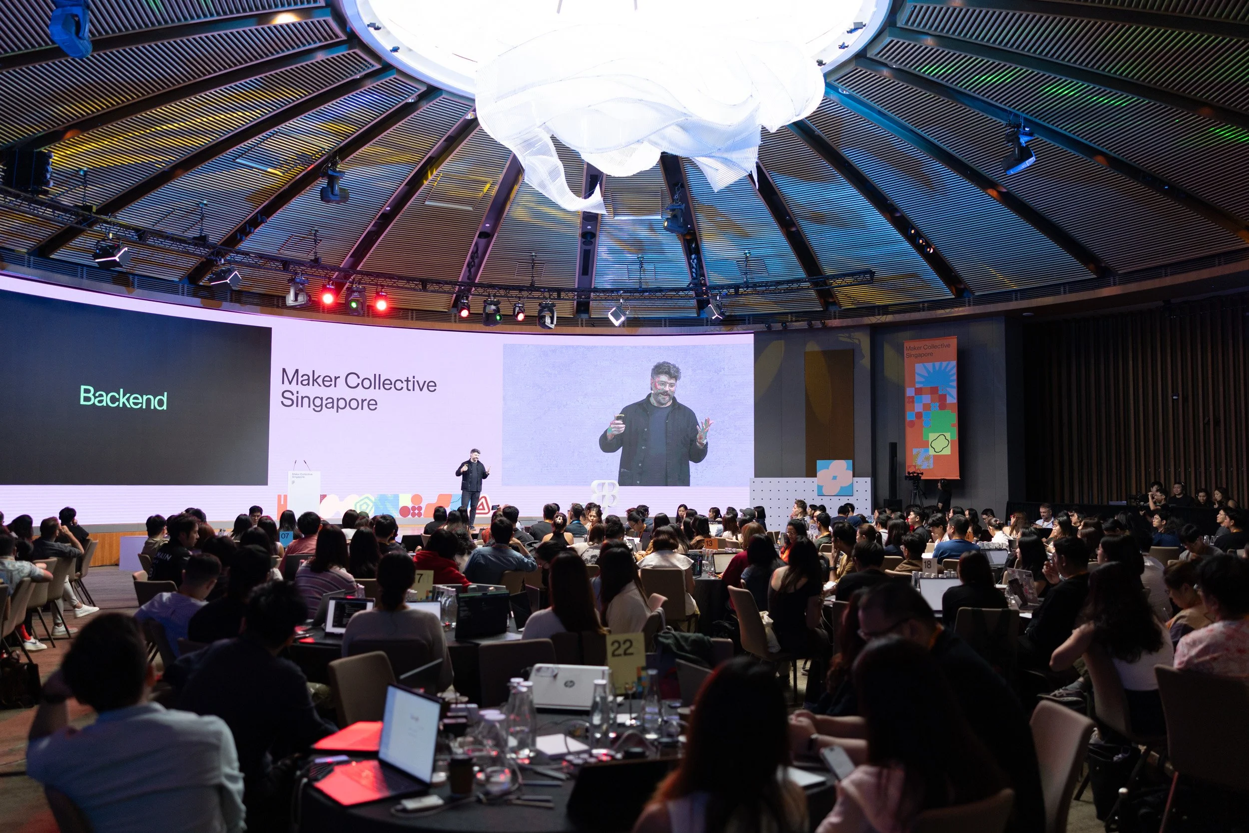  Wide angle stage photograph of Jonathan Summers-Muir addressing attendees. 