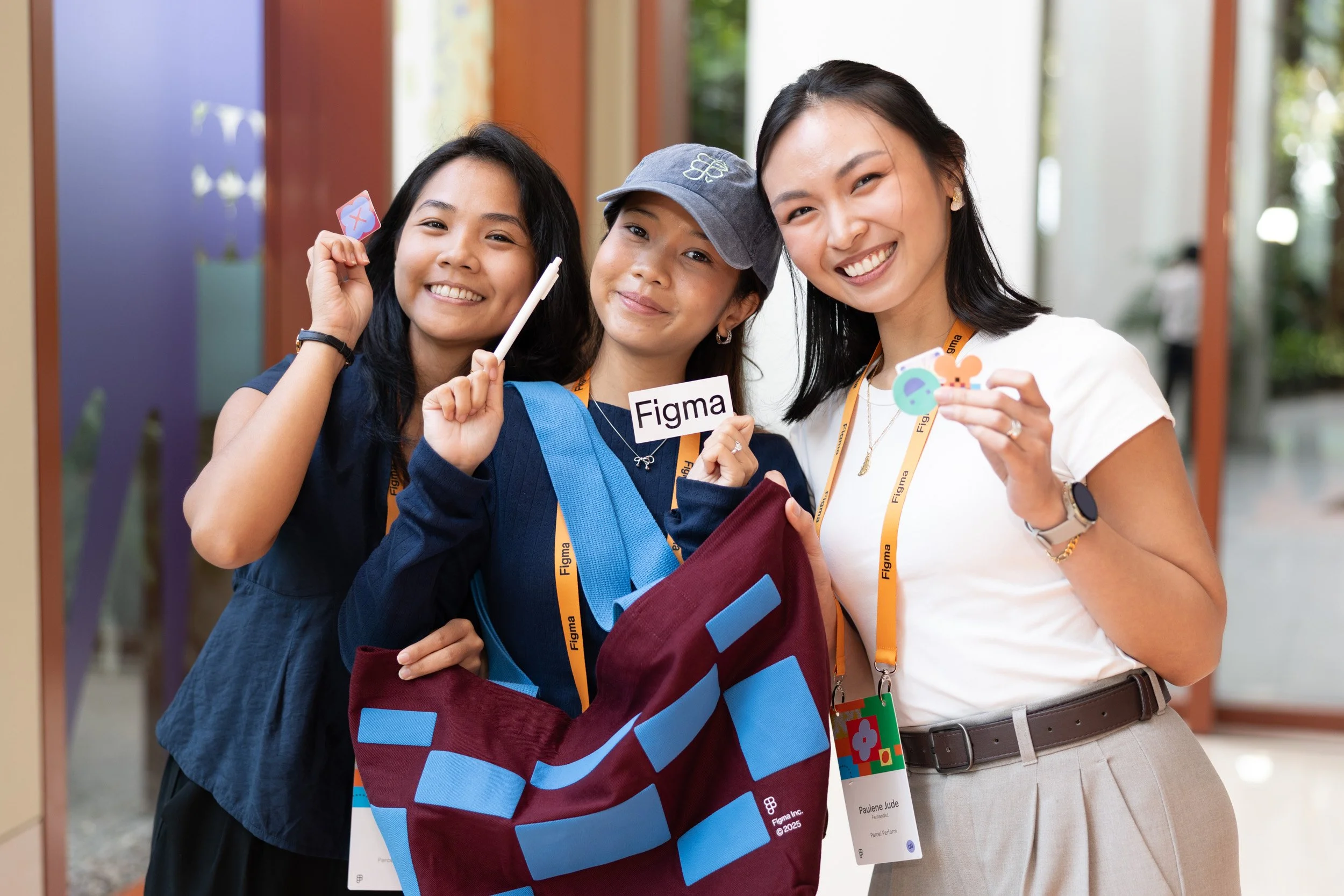  Posed group photo of attendees holding official Figma Maker Collective swag gift bags. 