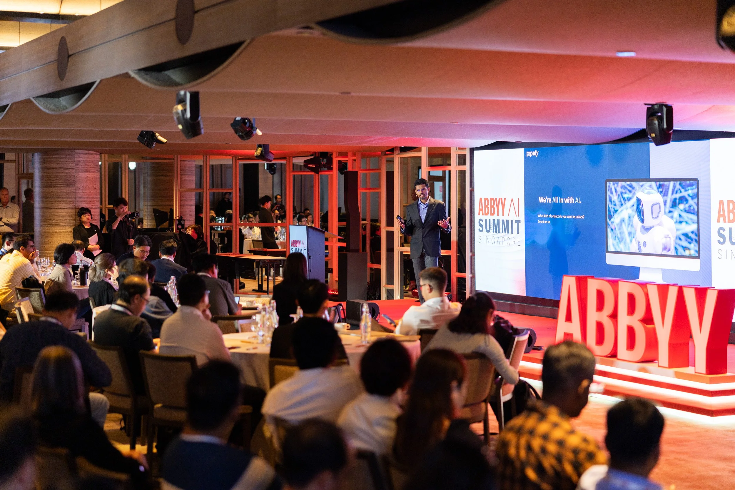  Medium perspective of Manoj Bhat delivering his presentation to delegates at PARKROYAL COLLECTION Marina Bay. 