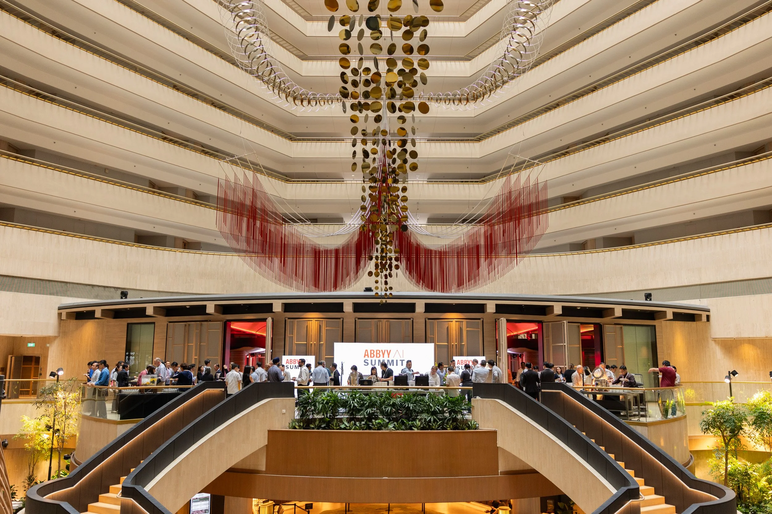  Symmetrical architectural shot capturing the hotel atrium and pre-function foyer directly from the front entrance. 