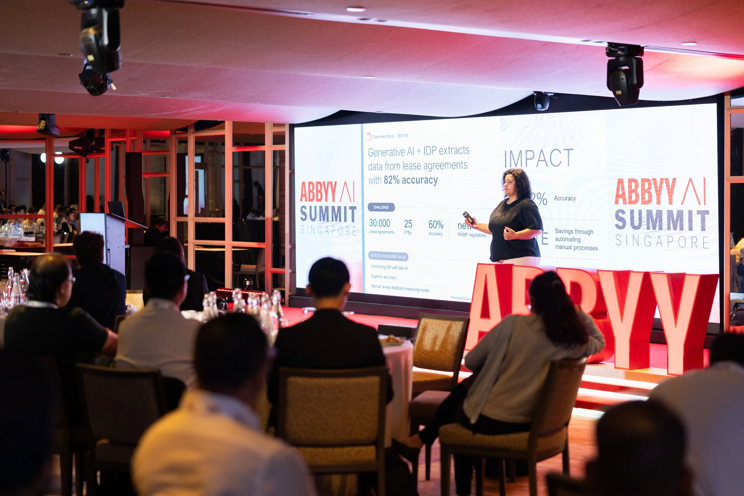  Medium portrait of Slavena Hristova speaking to attendees during the AI Summit Singapore. 