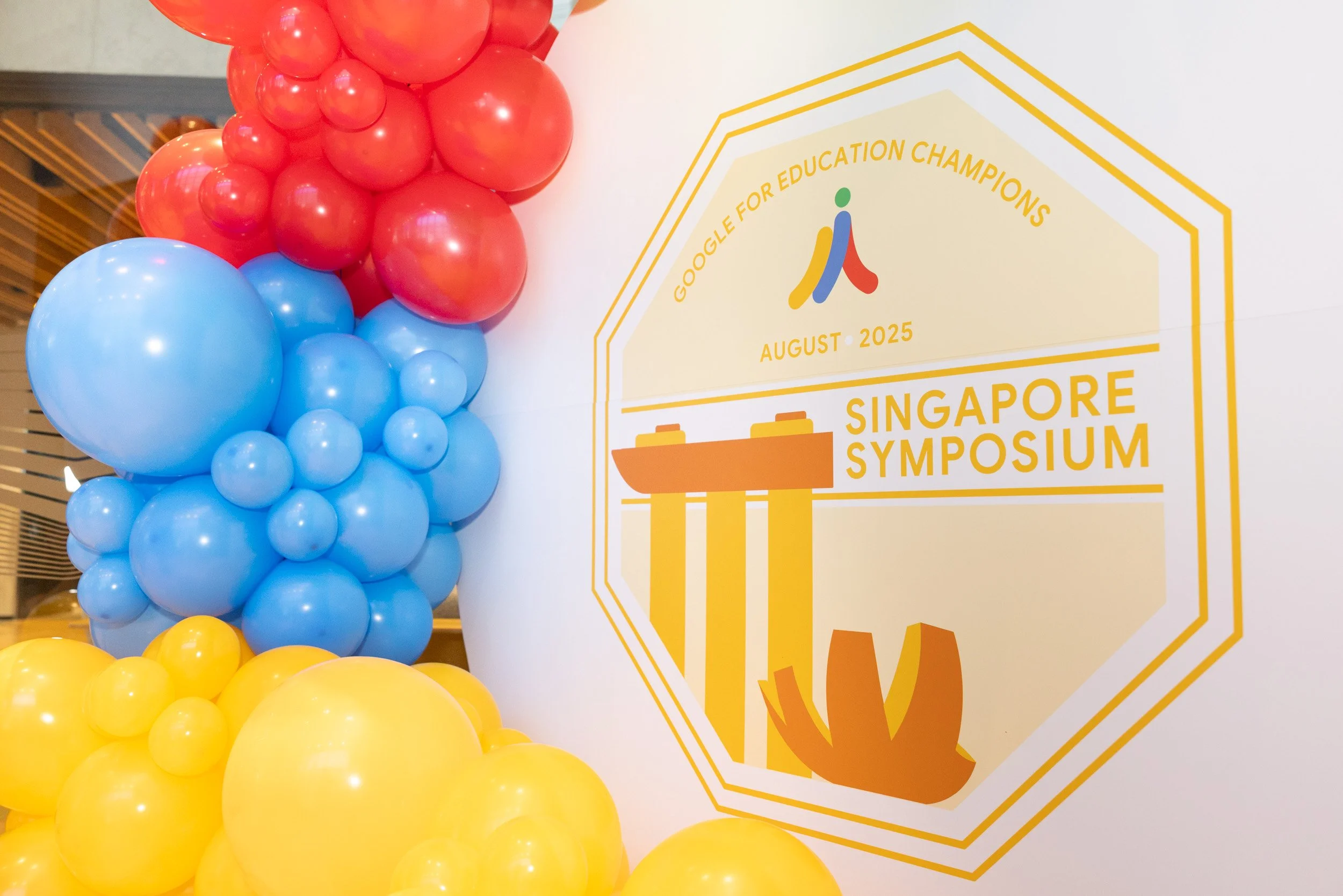  Branded event wall with balloon decorations reading Google for Education Champions August 2025 Singapore Symposium at Google Asia Pacific Headquarters. 