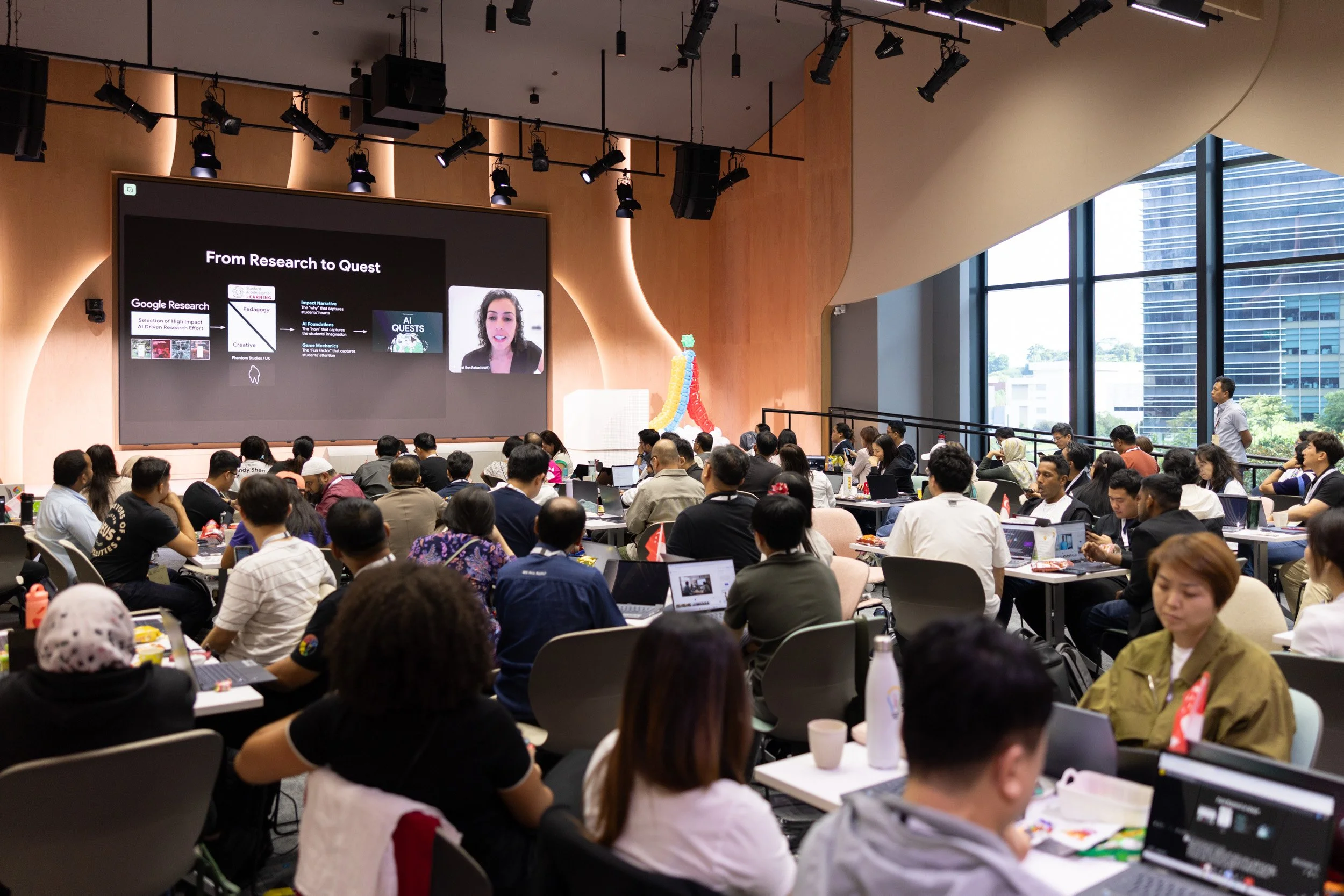  Wide angle shot of Liat Ben-Rafael presenting via live virtual screen stream during the conference. 