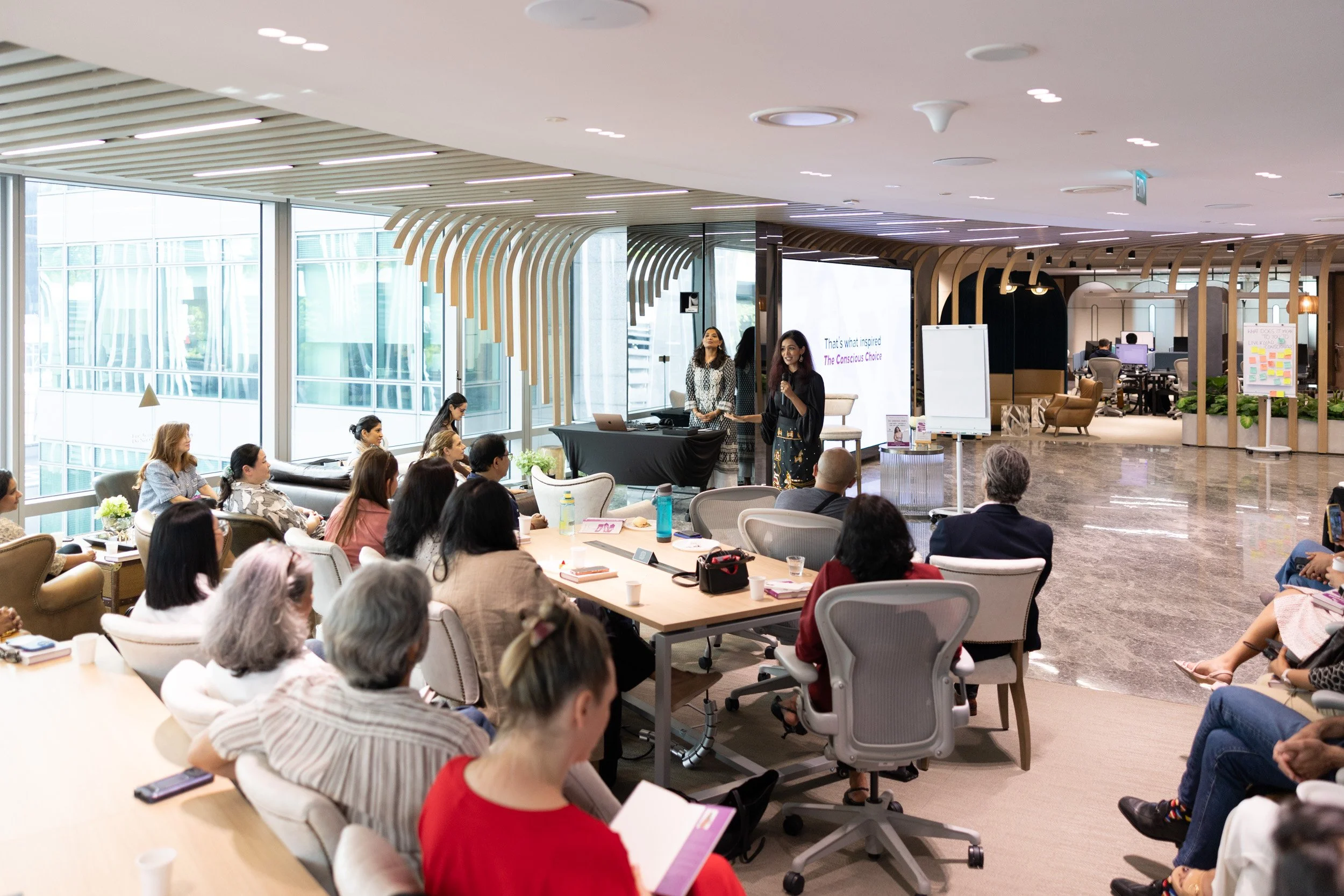  Wide angle stage photograph of keynote speaker Bhavna Toor addressing guests at Shenomics event. 