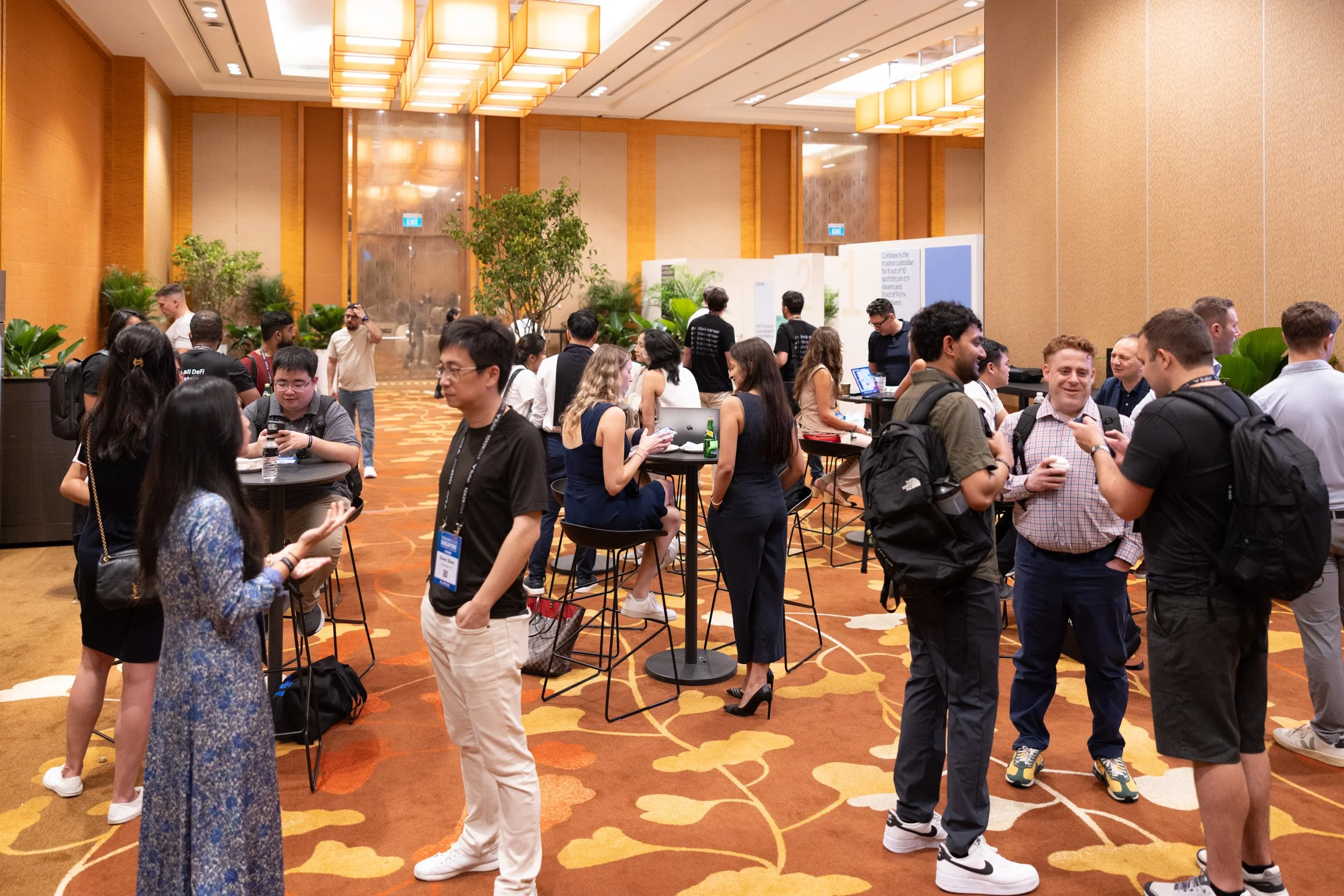  Wide angle event photography of attendees and executives networking at the Coinbase activation area. 