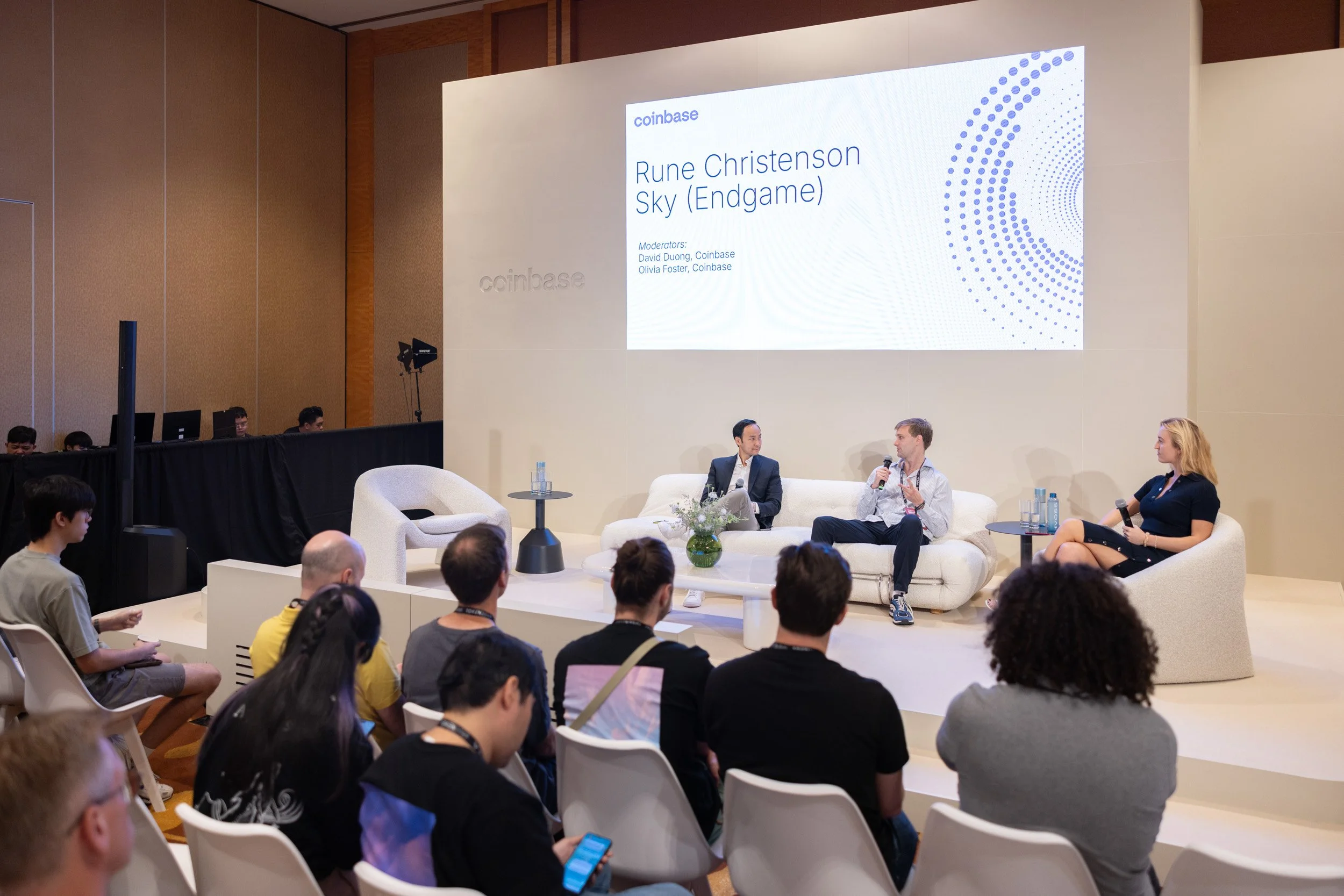  Rune Christensen, David Duong, and Olivia Foster leading a featured panel discussion on stage. 