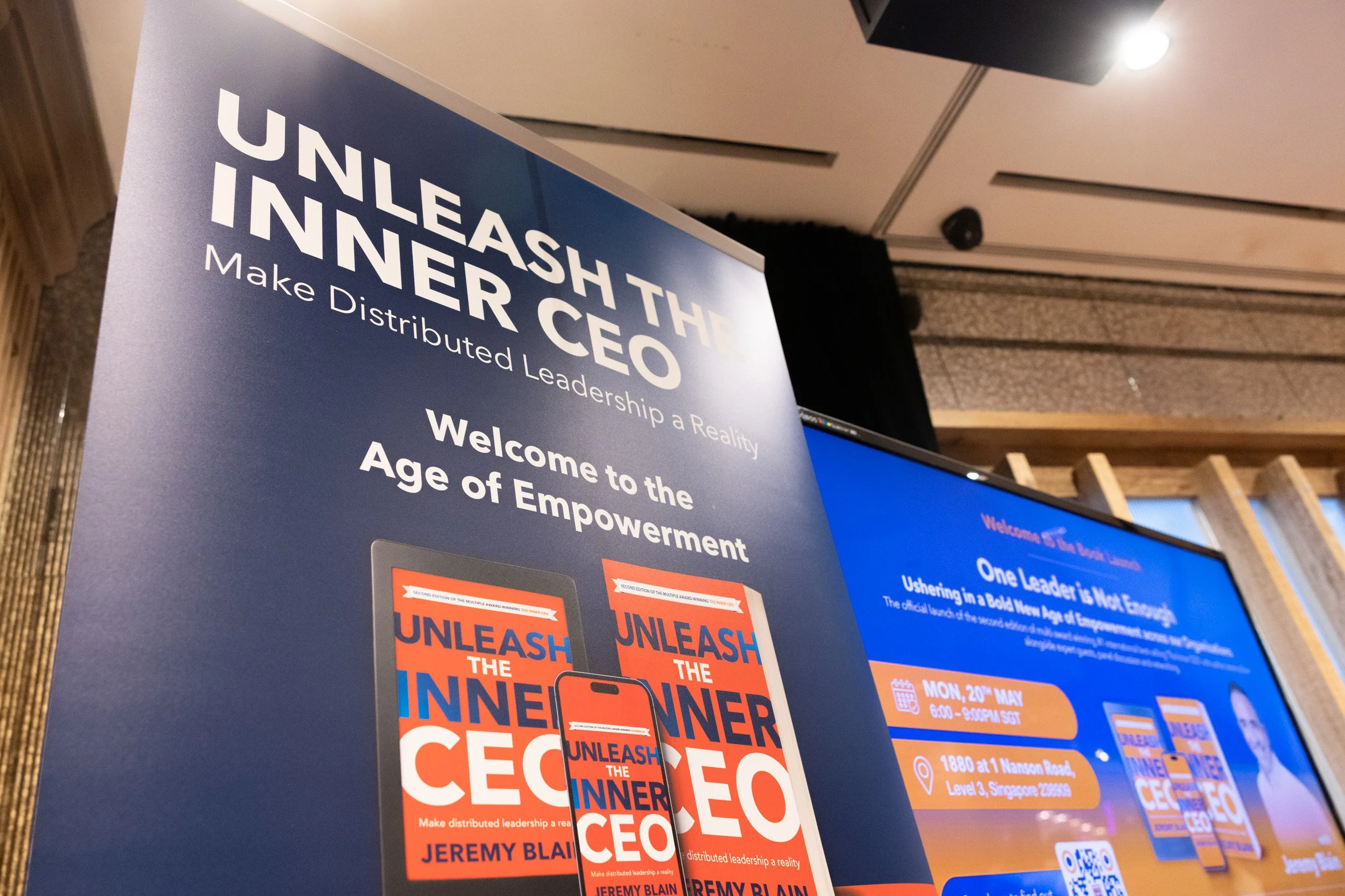  Close-up photo of the official event display banner for the Unleash the Inner CEO book launch at 1880 Singapore. 