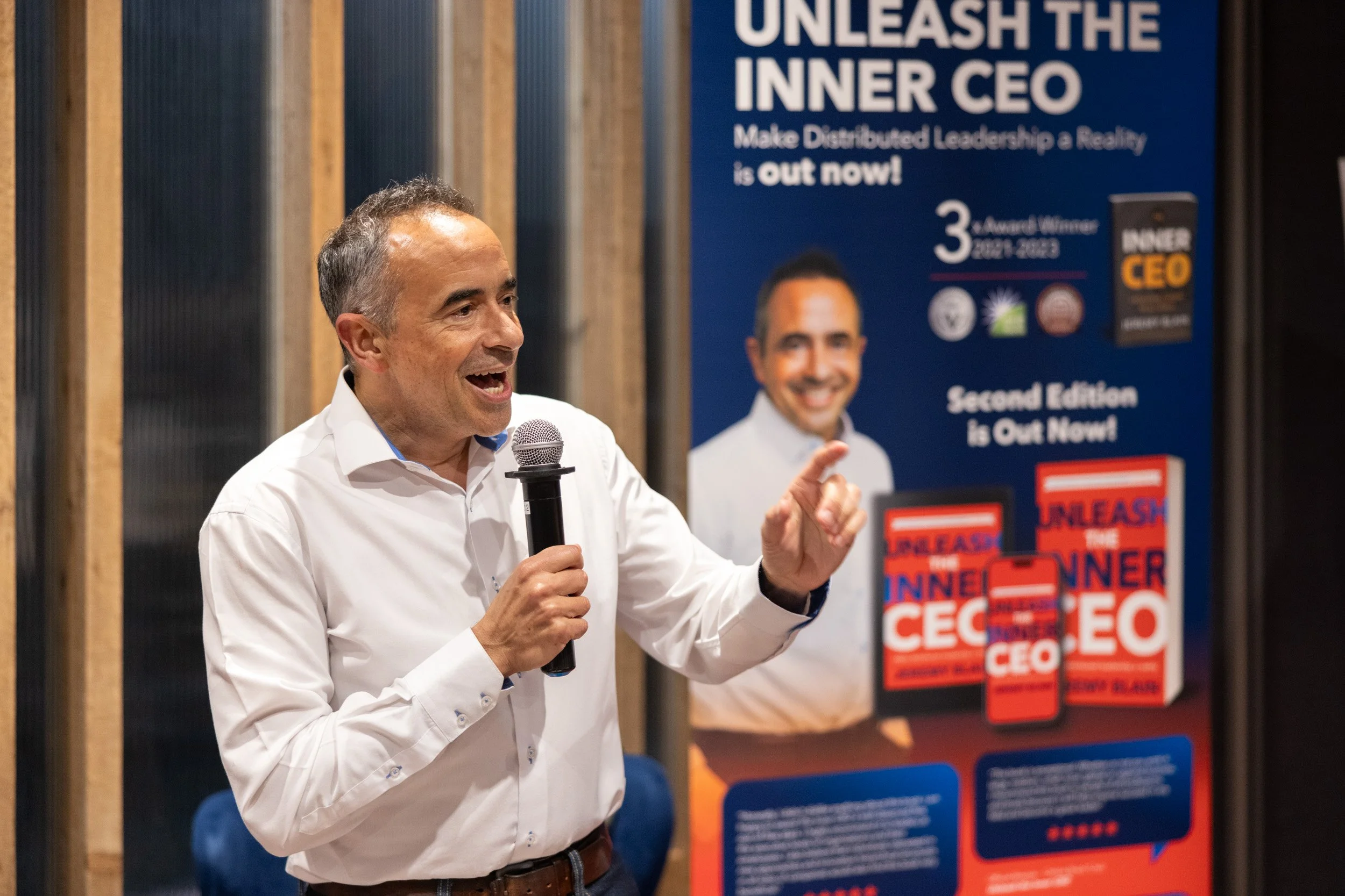  Close-up portrait of Jeremy Blain speaking during the executive panel portion of the event. 