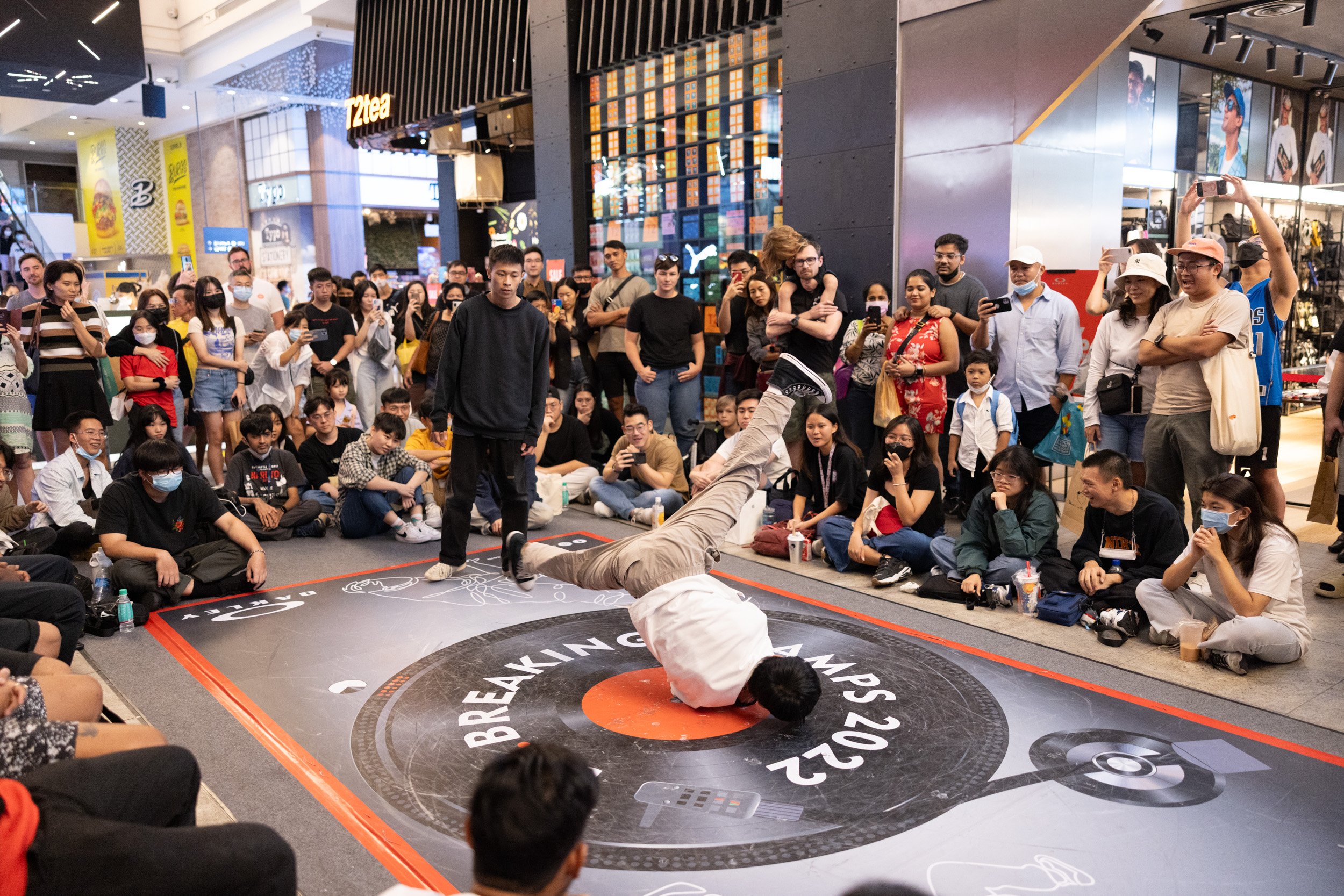  Eye-level action photograph of a breakdancer performing a fast windmill power move. 