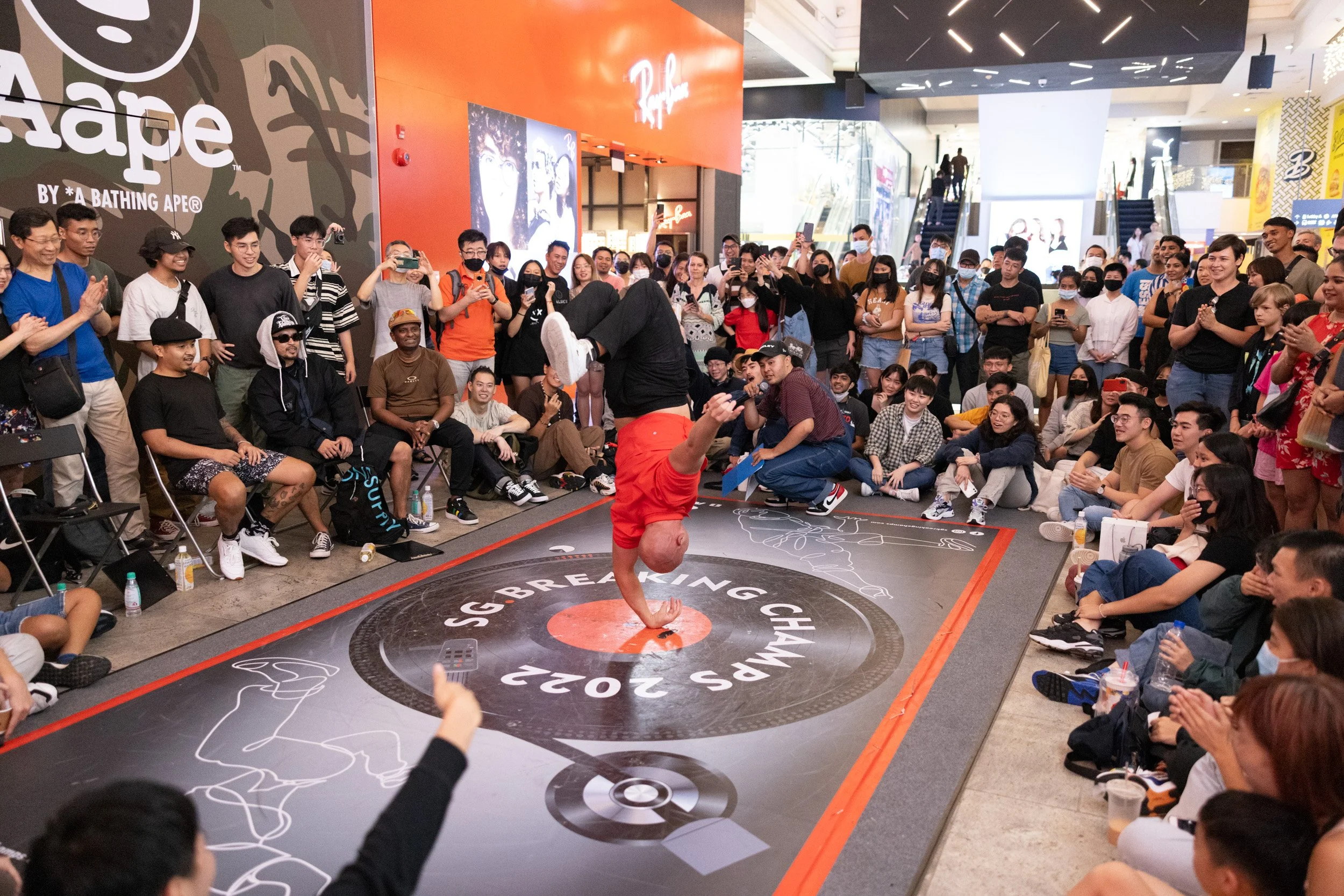 Eye-level medium-range shot of a breakdancer balancing in a modified 1990 wrist spin pose. 