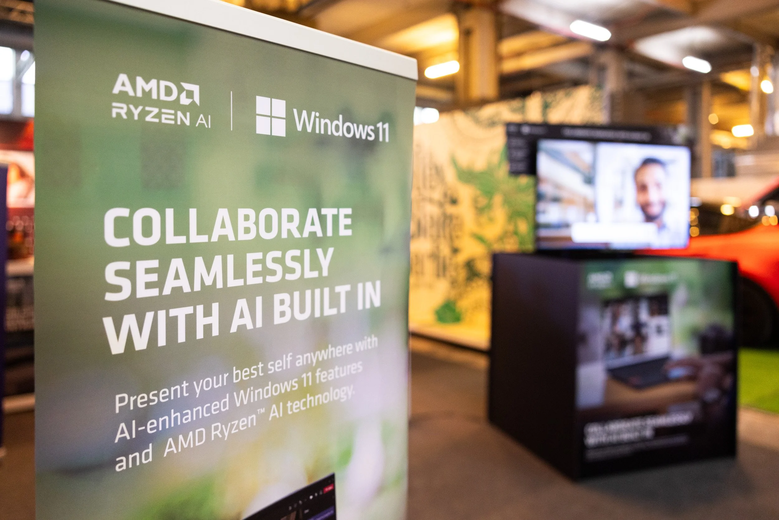  Promotional display poster highlighting AMD Ryzen AI built-in features and seamless collaboration tech. 